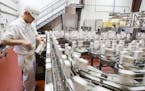 Rhett Peters takes samples of soy milk containers at the SunOpta plant, which produces aseptic, shelf-stable beverages, in Alexandria on Wednesday, Ju