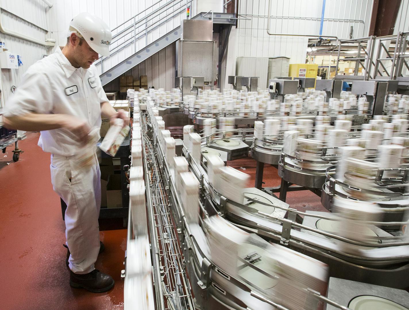 Rhett Peters takes samples of soy milk containers at the SunOpta plant, which produces aseptic, shelf-stable beverages, in Alexandria on Wednesday, July 8, 2015. ] LEILA NAVIDI leila.navidi@startribune.com /