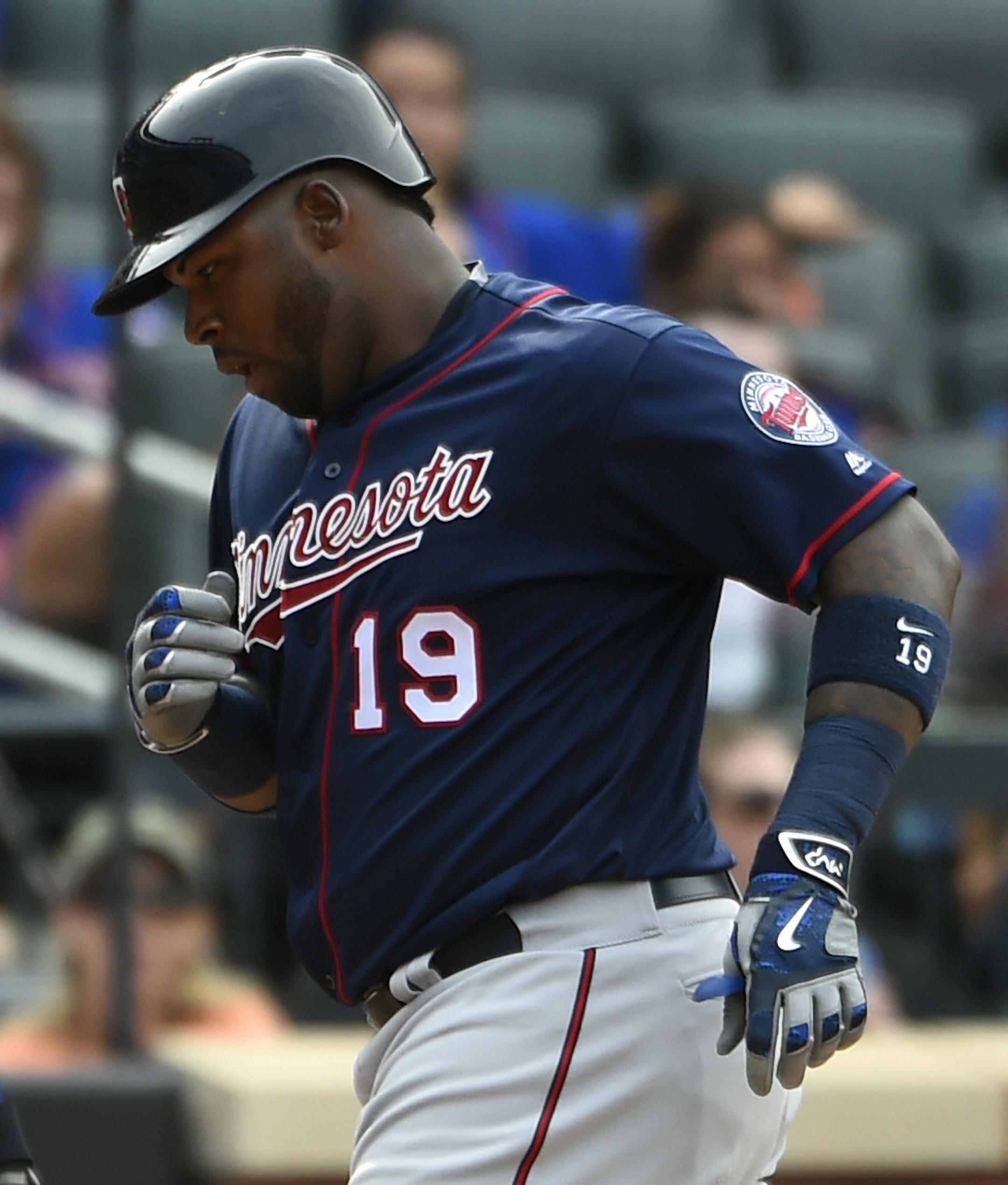 Minnesota Twins Kennys Vargas (19) crosses home plate in front of New York Mets catcher Travis d'Arnaud after hitting a solo home run in the eighth inning of a baseball game, Sunday, Sept. 18, 2016, in New York. (AP Photo/Kathy Kmonicek)