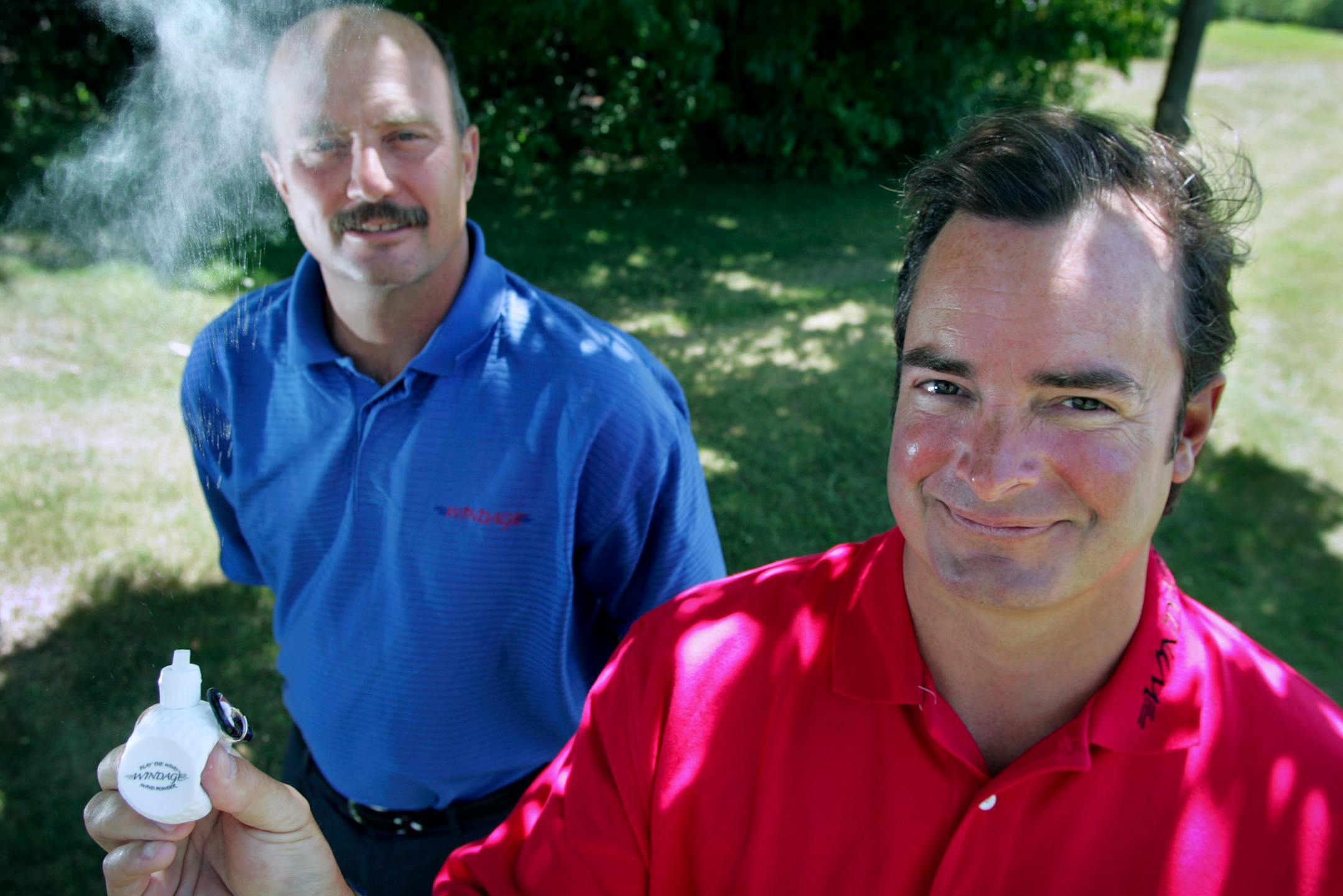 Orono resident David Healy, right, and business partner Brian Trachsel invented Windage, a golf-ball shaped product filled with talcum powder intended to help golfers determine the wind's direction.