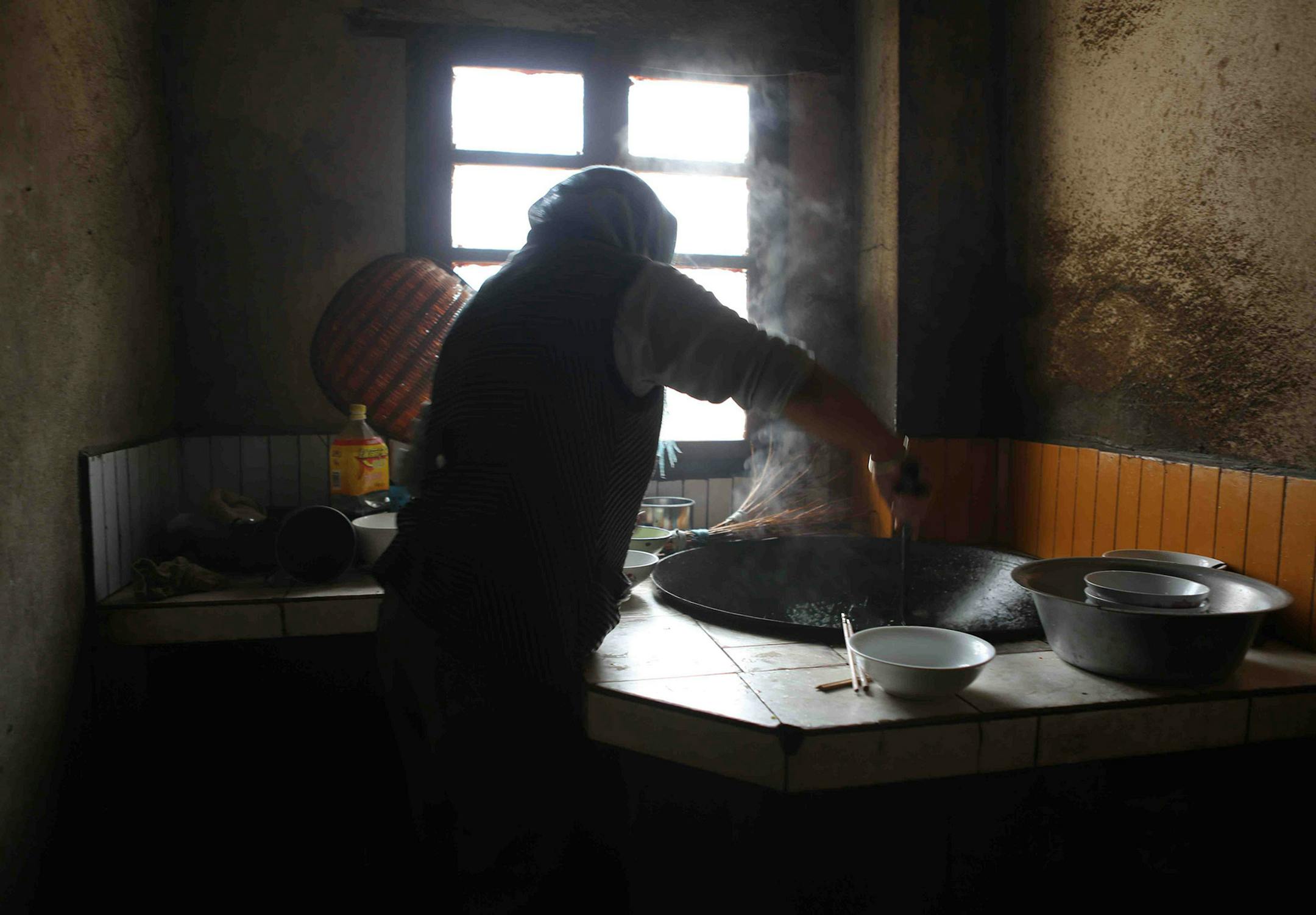 Photo by Mirra Fine, the Perennial Plate Ms. Yang's mother preparing the wok