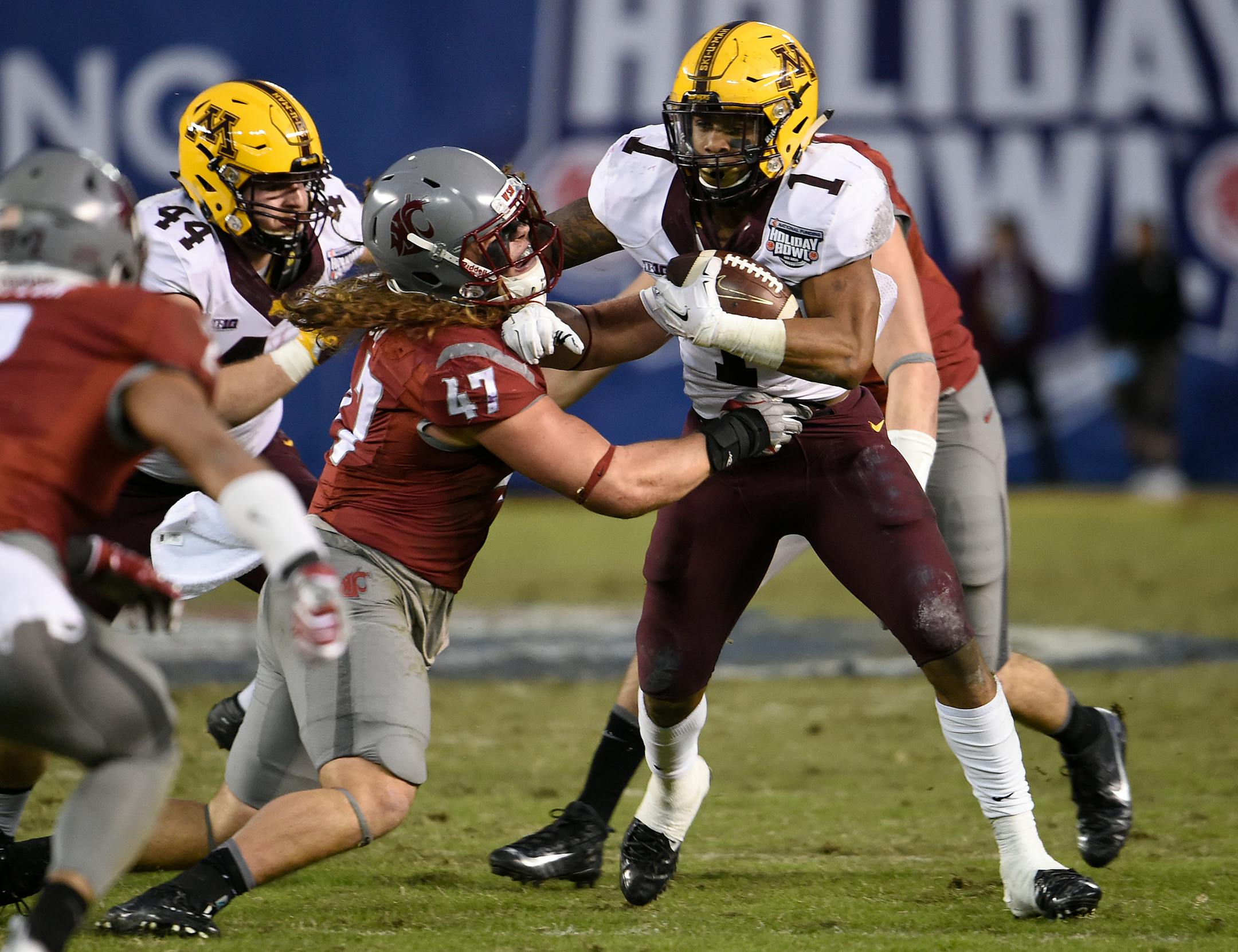 Gophers running back Rodney Smith broke the tackle of Washington State linebacker Peyton Pelluer during the first half of the Holiday Bowl on Tuesday night.