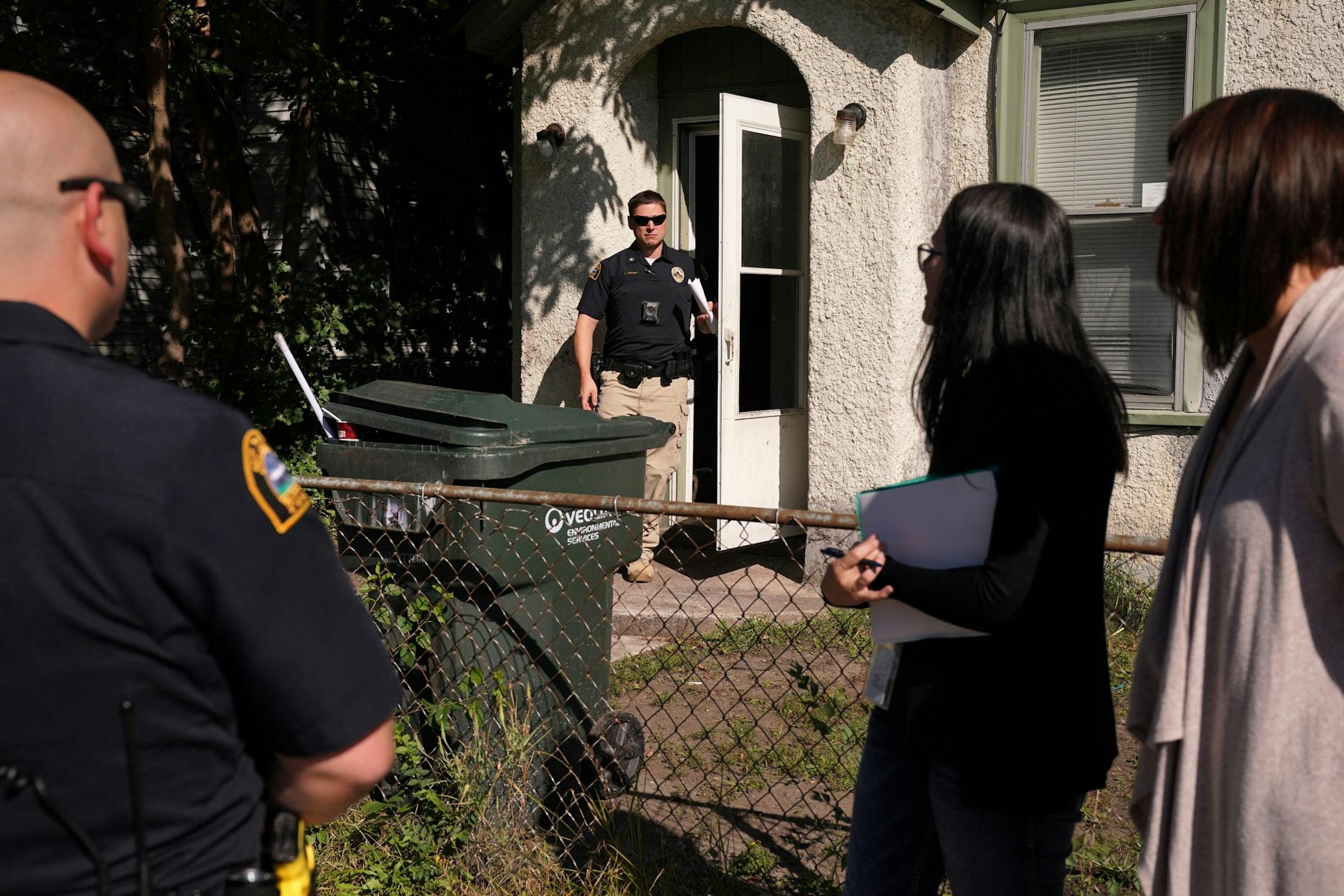 Licensed clinical social workers Kara Haroldson, center, and Amber Ruth, right accompanied officers center Justin Tiffany and Marshall Titus left on a call.