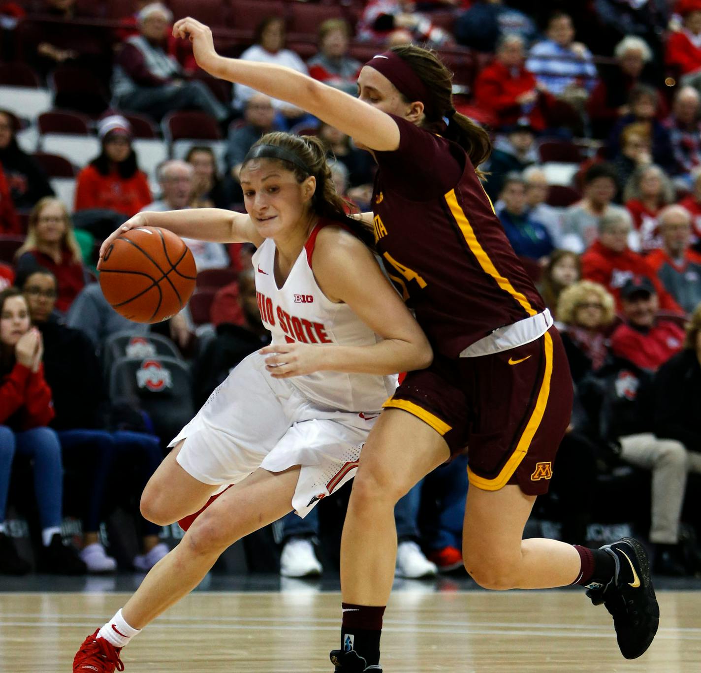 Ohio State's Jacy Sheldon, left, drives against Minnesota's Masha Adashchyk at Value City Arena in Columbus, Ohio, on Thursday