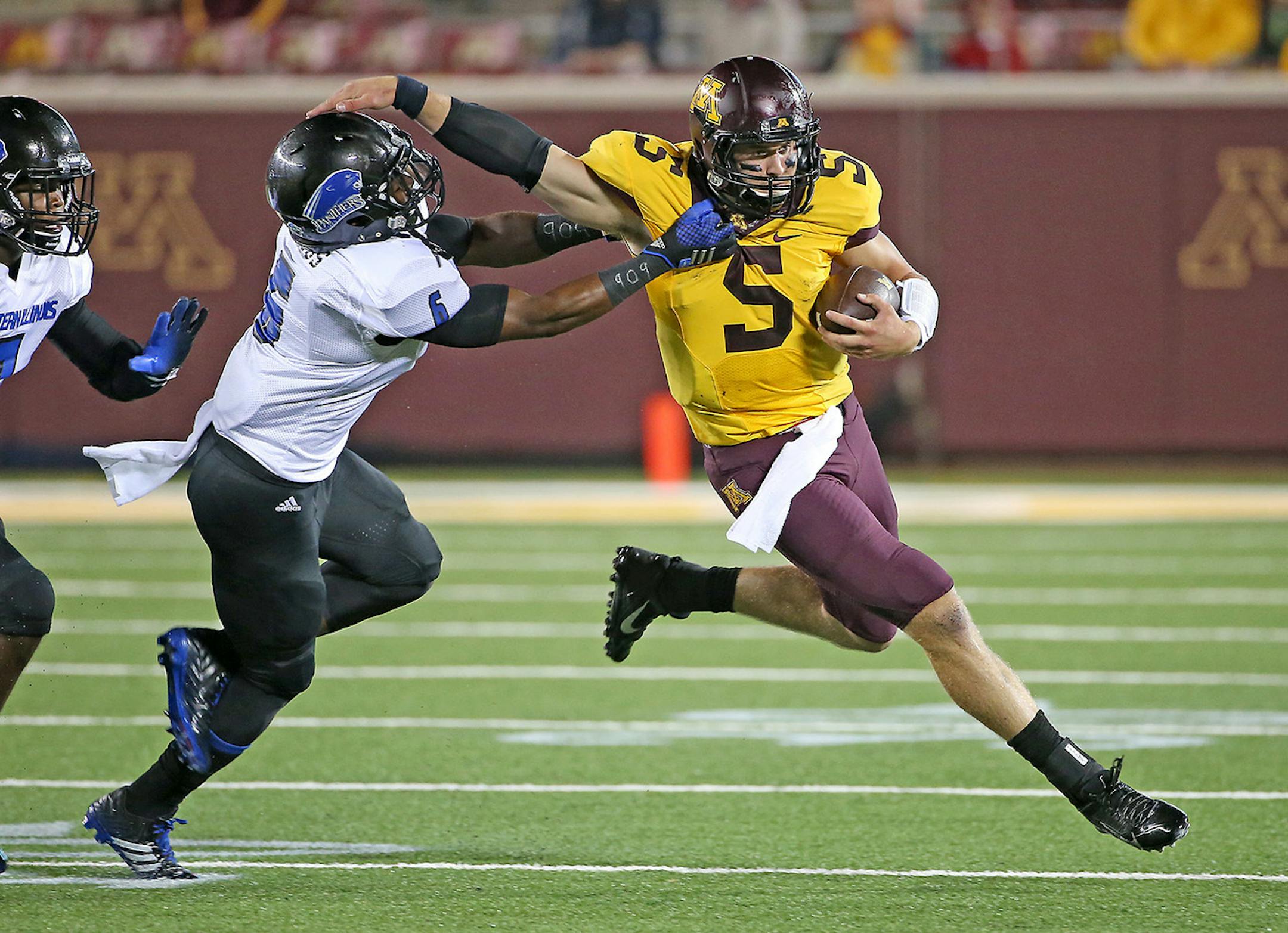 Minnesota quarterback Chris Streveler ran for a first down despite pressure from Eastern Illinois defensive back Cedric Julius during the fourth quarter of the opening game against Eastern Illinois, Thursday, August 28, 2014 in Minneapolis, MN. ] (ELIZABETH FLORES/STAR TRIBUNE) ELIZABETH FLORES • eflores@startribune.com