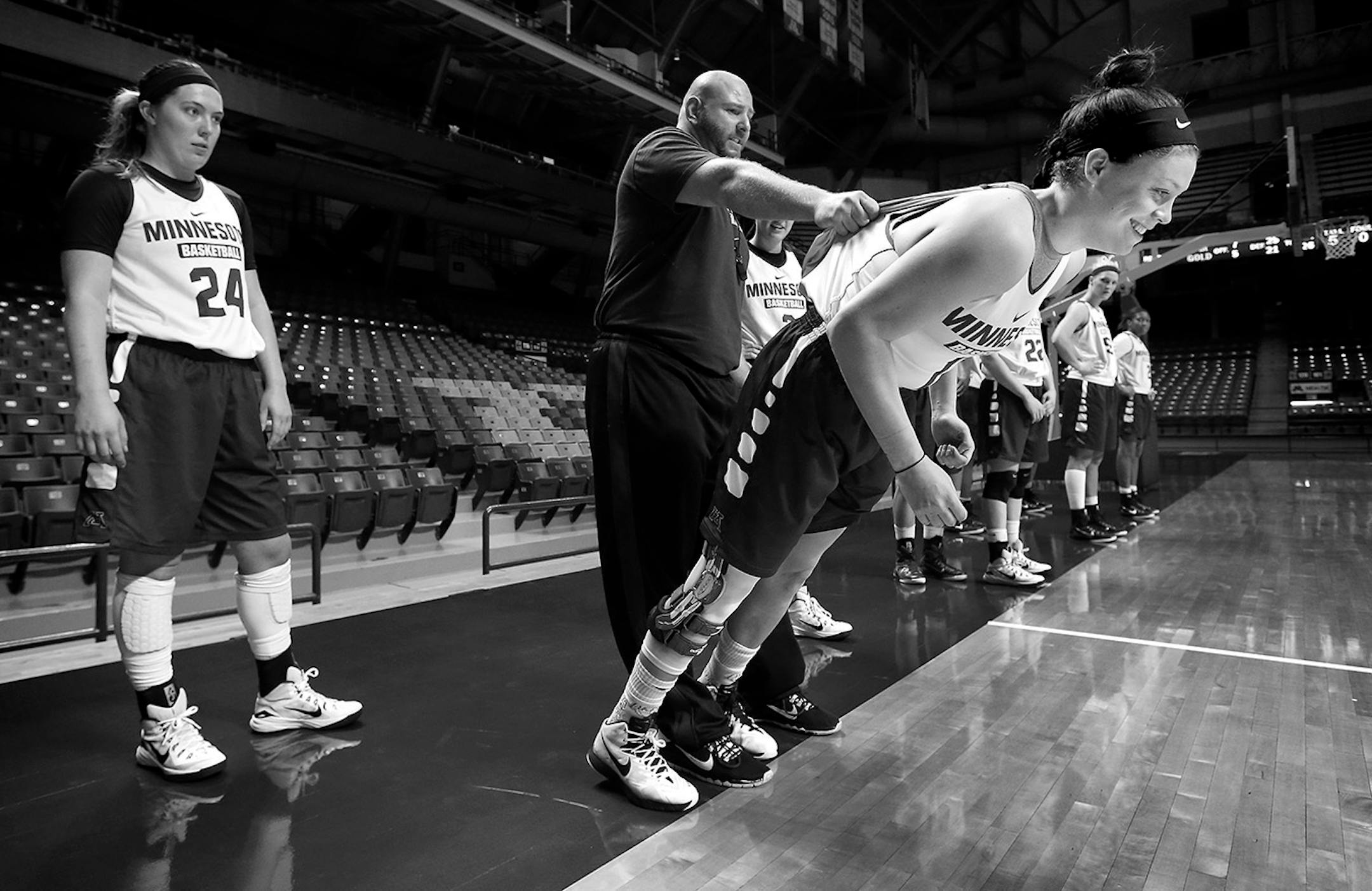 Strength and conditioning coach Ralph Petrella held Rachel Banham during an exercise at practice at Williams arena on October 29, 2015.