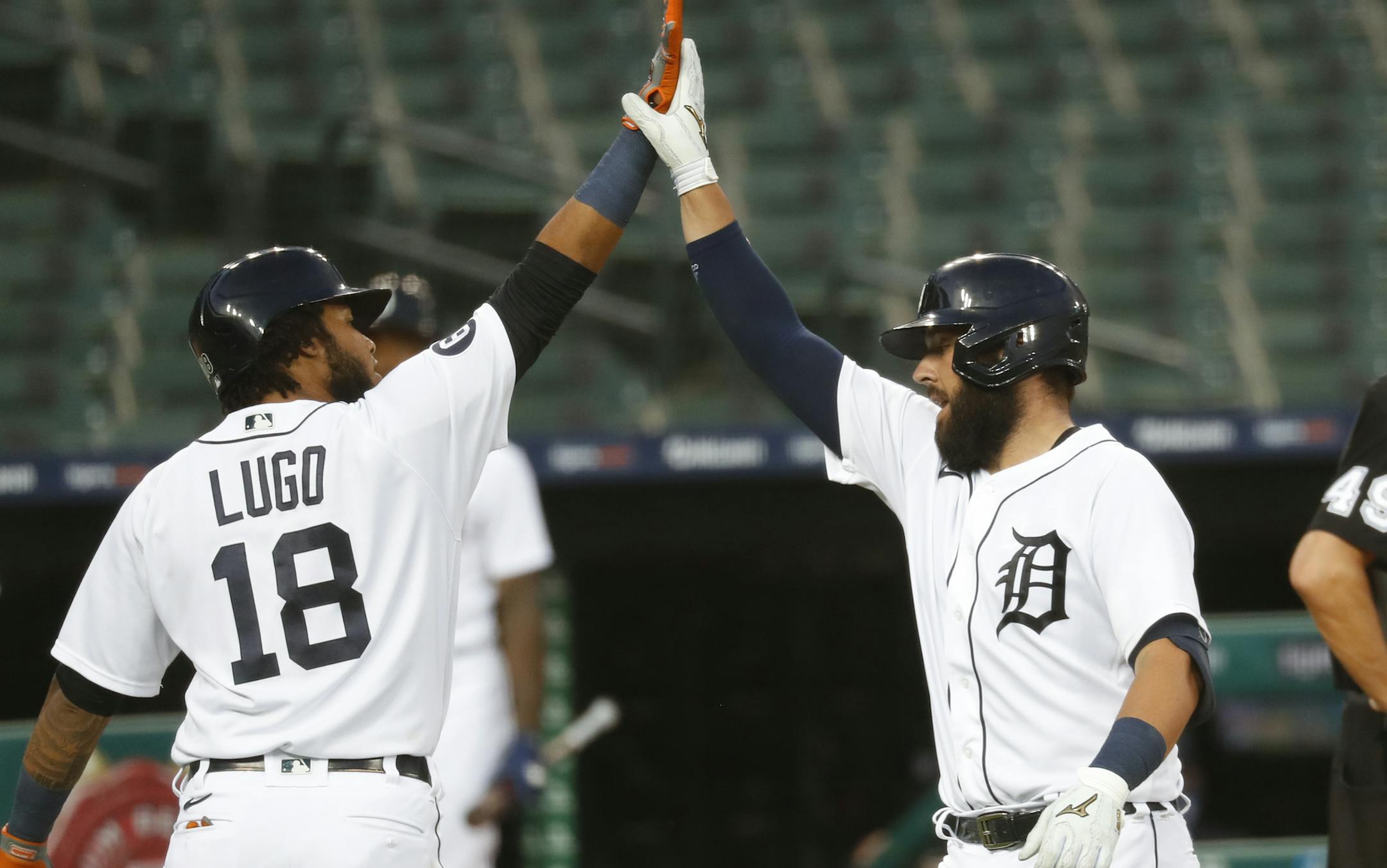 Detroit Tigers' Austin Romine, right, celebrates his two-run home run with Dawel Lugo (18) against the Chicago White Sox in the fifth inning of a baseball game in Detroit, Tuesday, Aug. 11, 2020. (AP Photo/Paul Sancya)