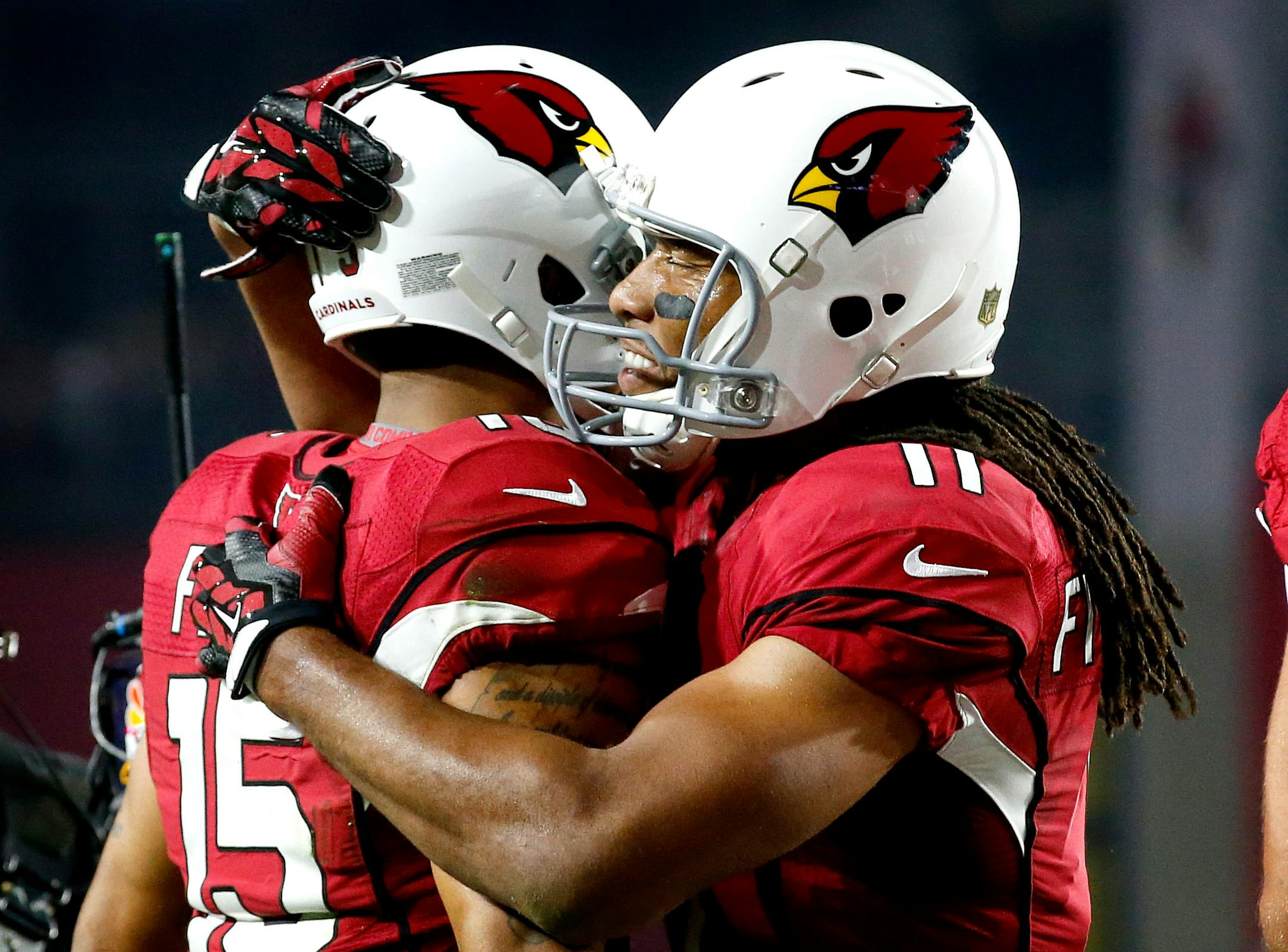 Arizona Cardinals wide receiver Michael Floyd (15) celebrates his touchdown catch with teammate Larry Fitzgerald (11) during the first half of an NFL divisional playoff football game against the Green Bay Packers, Saturday, Jan. 16, 2016, in Glendale, Ariz. (AP Photo/Ross D. Franklin)