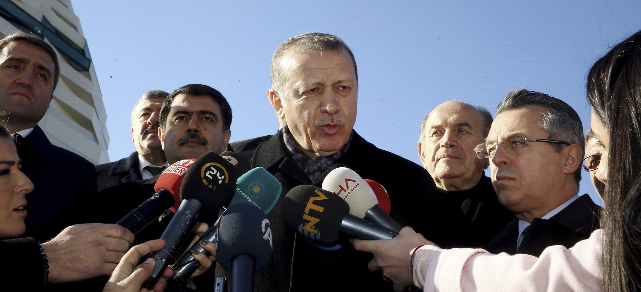 Turkey's President Recep Tayyip Erdogan speaks to the media after Friday prayers in Istanbul, Friday, Dec. 9, 2016. Erdogan has called on Turkish citizens to change their US dollars with the national currency, Turkish Lira.(Kayhan Ozer, Presidential Press Service, Pool photo via AP)