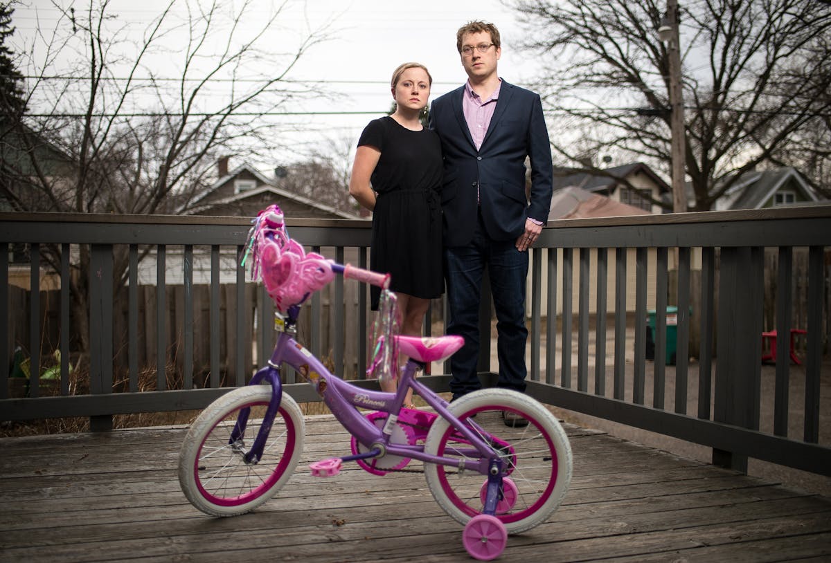 Hannah and David Edwards were photographed behind their home with their 5-year-old daughter's bicycle on Tuesday, April 12, 2016 in St. Paul, Minn. ] 