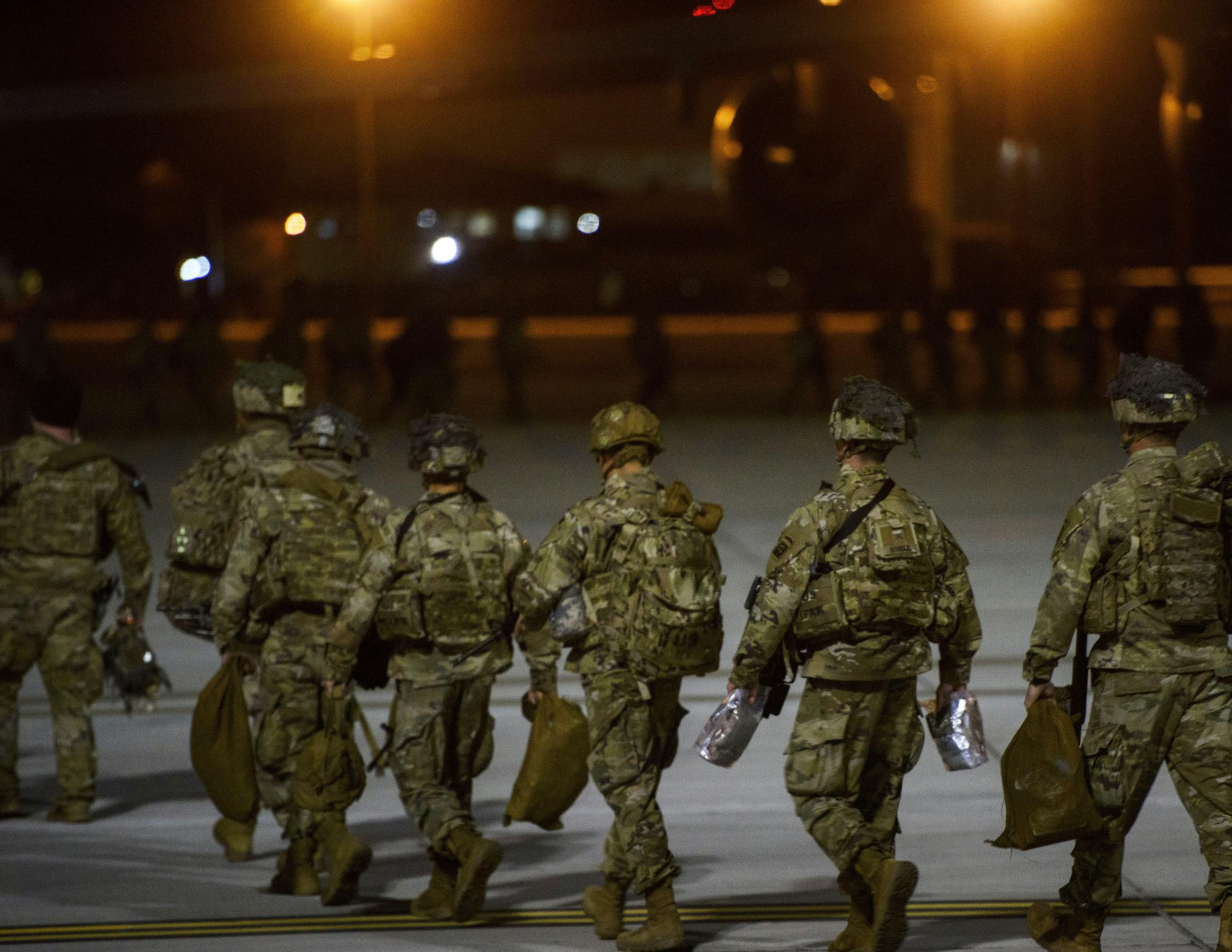 FILE - In this Wednesday, Jan. 1, 2020, file photo, U.S. Army soldiers from the 82nd Airborne board a C-17 aircraft at Fort Bragg, N.C., to be deployed to the Middle East. In addition to these troops, the United States is sending nearly 3,000 more soldiers to the Mideast as reinforcements in the volatile aftermath of the killing of Iranian Gen. Qassem Soleimani, defense officials said Friday, Jan. 3. (Melissa Sue Gerrits/The Fayetteville Observer via AP, File)