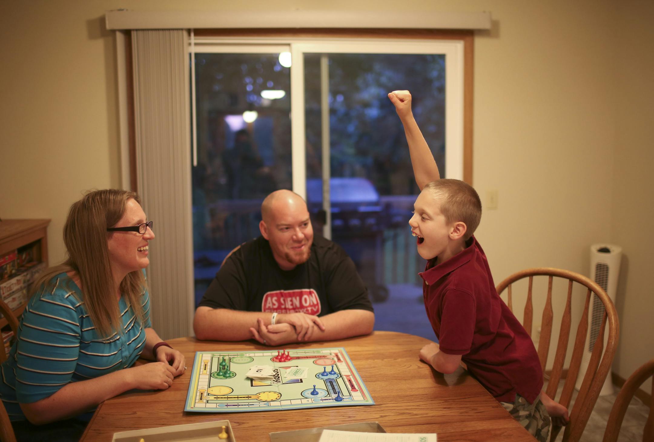 Heidi and Dan Mouw's son reacted to defeating his parents in a game of "Sorry" at home Monday night. ] JEFF WHEELER ï jeff.wheeler@startribune.com After Heidi Mouw posted online about her young son's thoughts of suicide, she received a wave of support ñ something professionals say parents with kids with mental illness don't often receive. In their Shoreview home Monday evening, August 22, 2016, Heidi and her husband, Dan, played board games with their eight year-old son.