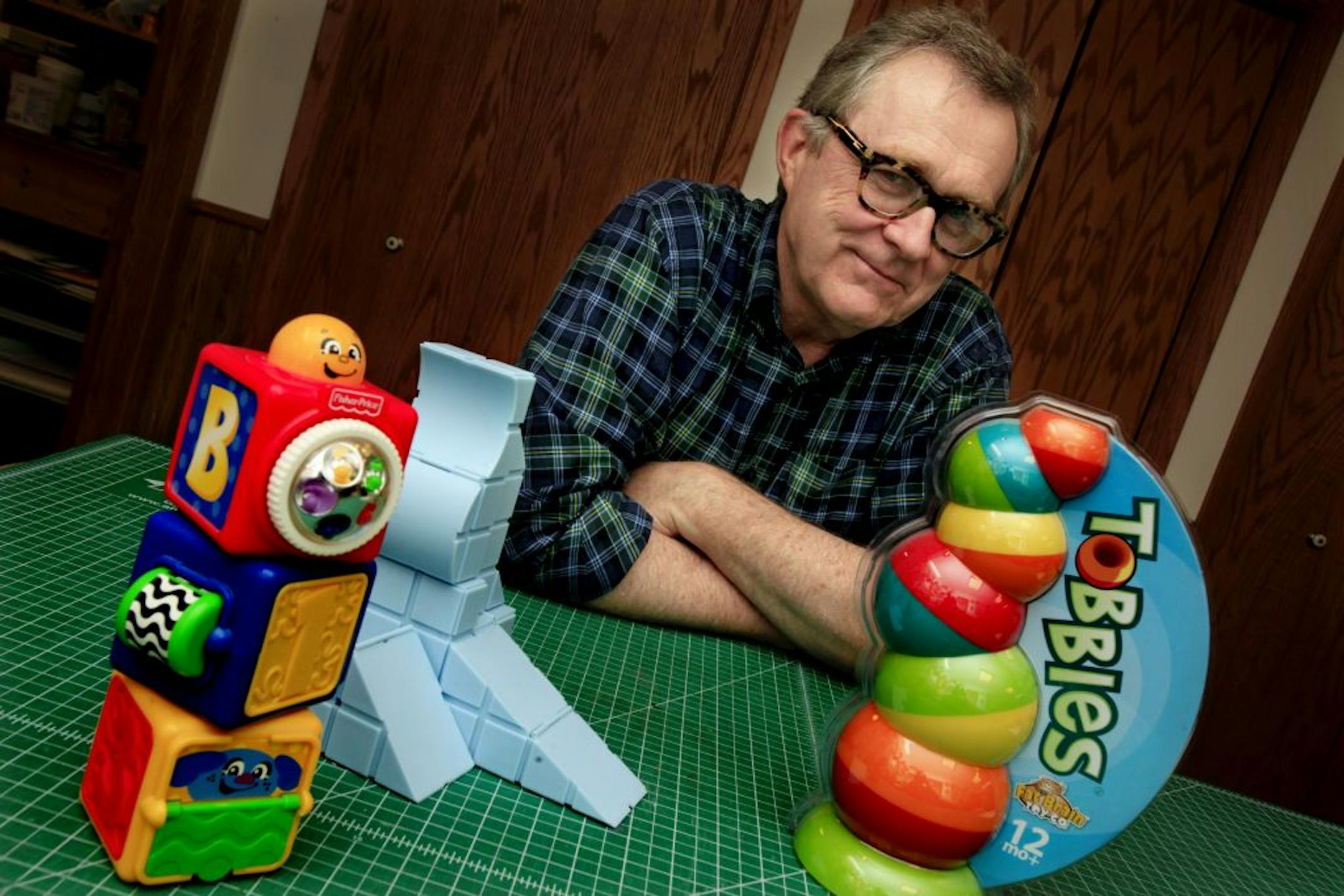 Tony Morley at his home shop in West Lakeland Township, is a toy tinkerer/inventor who has invented several toys for several toy makers. For Fisher Price he has inventerd Block Builder (front left), and for Fat Brain hes has invented Stacking Action Blocks (center blue colored toy) and recently has invented Tobbles for Fat Brain. May 29, 2012.