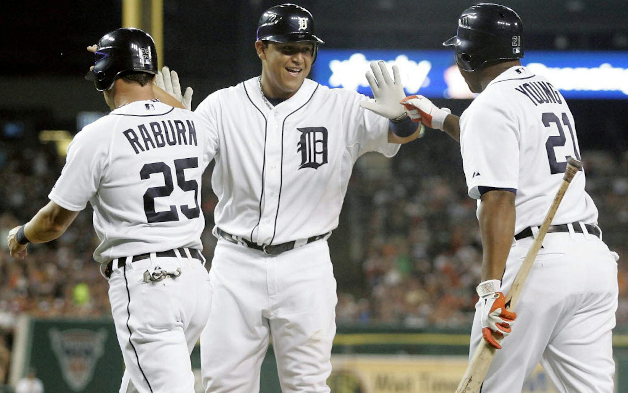 Detroit's Miguel Cabrera, center, is congratulated by Delmon Young (21) after scoring with Ryan Raburn (25) on a double by Prince Fielder in the first inning Wednesday.