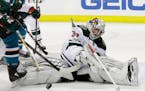 Minnesota Wild goalie Alex Stalock stops a shot against the San Jose Sharks during the second period of an NHL hockey game Sunday, Dec. 10, 2017, in S