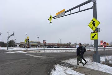 St. Francis High School students JP Krage, 14, and Tyler Forcier, 15, cross Hwy. 47 after school Wednesday, near where two middle school students were