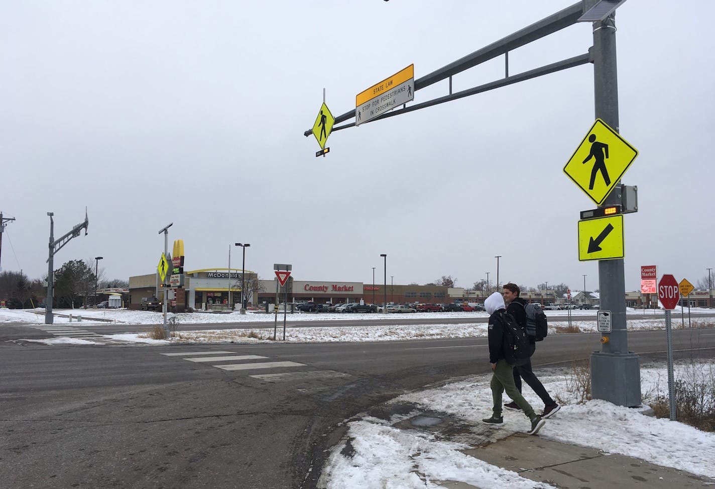 St. Francis High School students JP Krage, 14, and Tyler Forcier, 15, cross Hwy. 47 after school Wednesday, near where two middle school students were hit and injured last month.