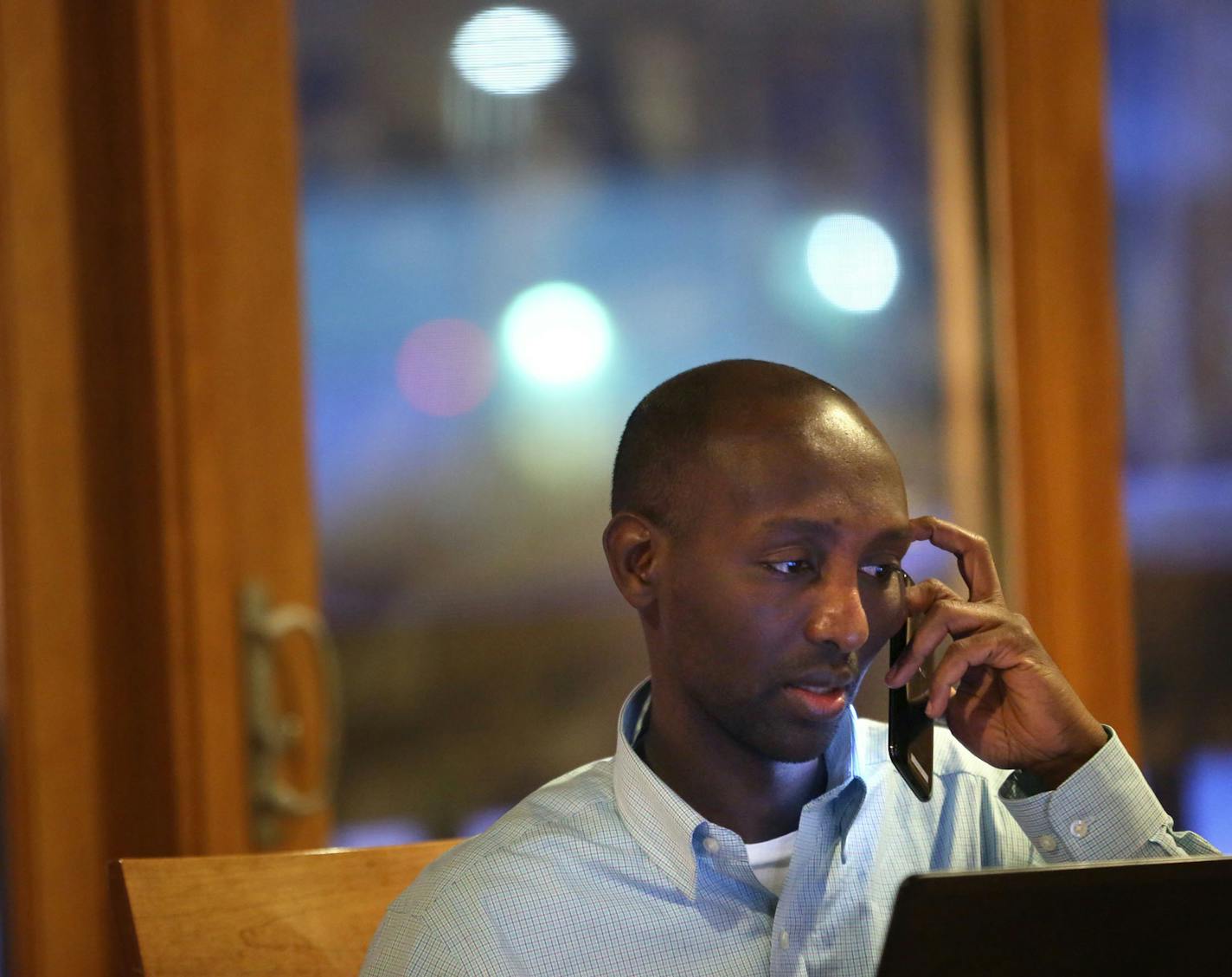 Mohamud Noor answered his phone that continued to ring as he worked before meeting campaign volunteers to call delegates at the community room in his apartment building in Minneapolis, Wednesday, February 5, 2014. ] (KYNDELL HARKNESS/STAR TRIBUNE) kyndell.harkness@startribune.com ORG XMIT: MIN1402052005380118