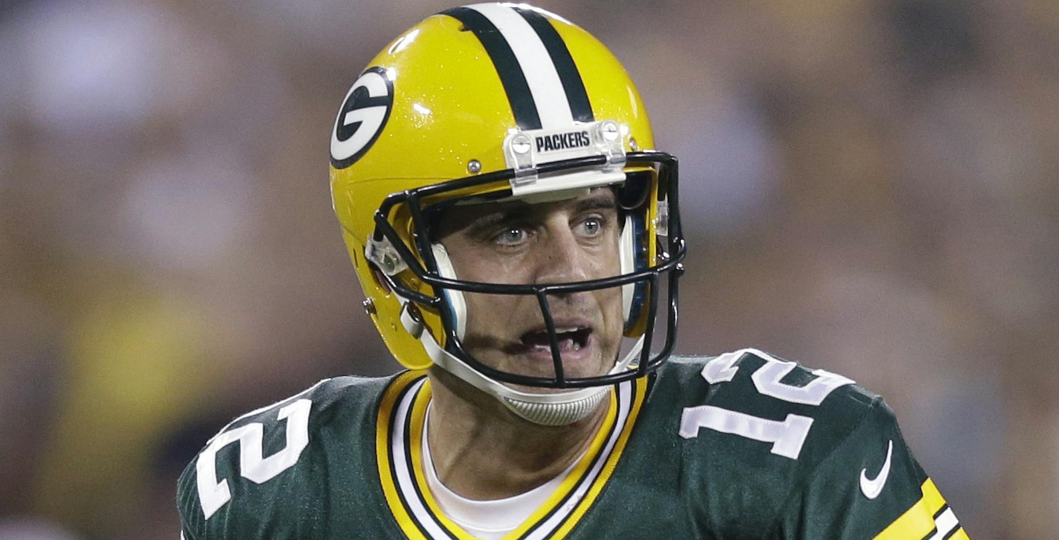 In this Aug. 22, 2014, photo, Green Bay Packers quarterback Aaron Rodgers approaches the line of scrimmage during the first half of an NFL preseason football game against the Oakland Raiders in Green Bay, Wis. Rodgers' first start at Seattle is making a lot of fantasy football owners squeamish. (AP Photo/Morry Gash)