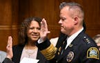 St. Paul Police Chief Axel Henry is sworn in by city clerk Shari Moore Wednesday, Nov. 16, 2022 at St. Paul City Hall in St. Paul, Minn.. To the left 