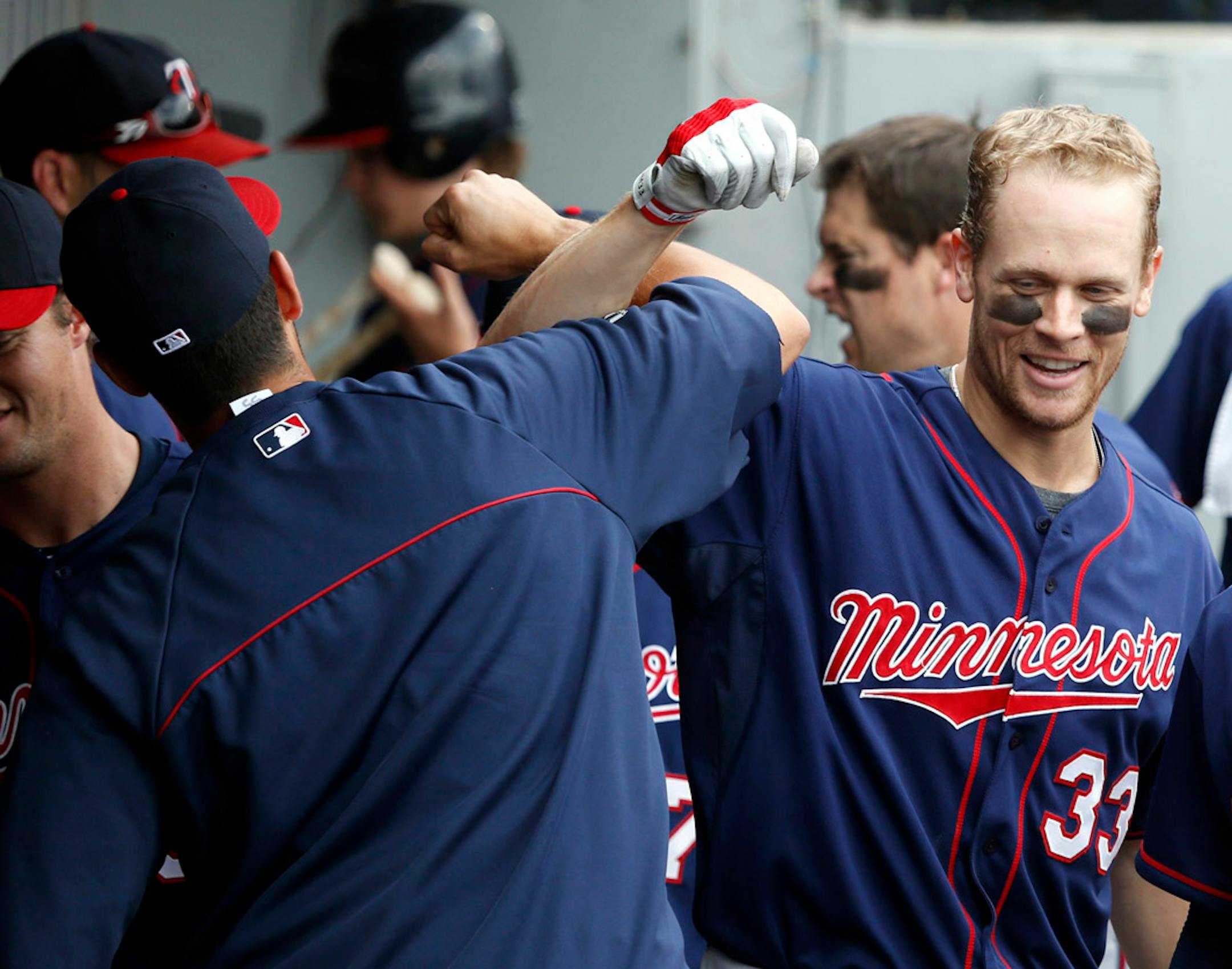 In this file photo, Twins' Justin Morneau (33) celebrates his home run with Chris Colabello in the dugout during the ninth inning of a baseball game against the Chicago White Sox on Friday, Aug. 9, 2013, in Chicago.