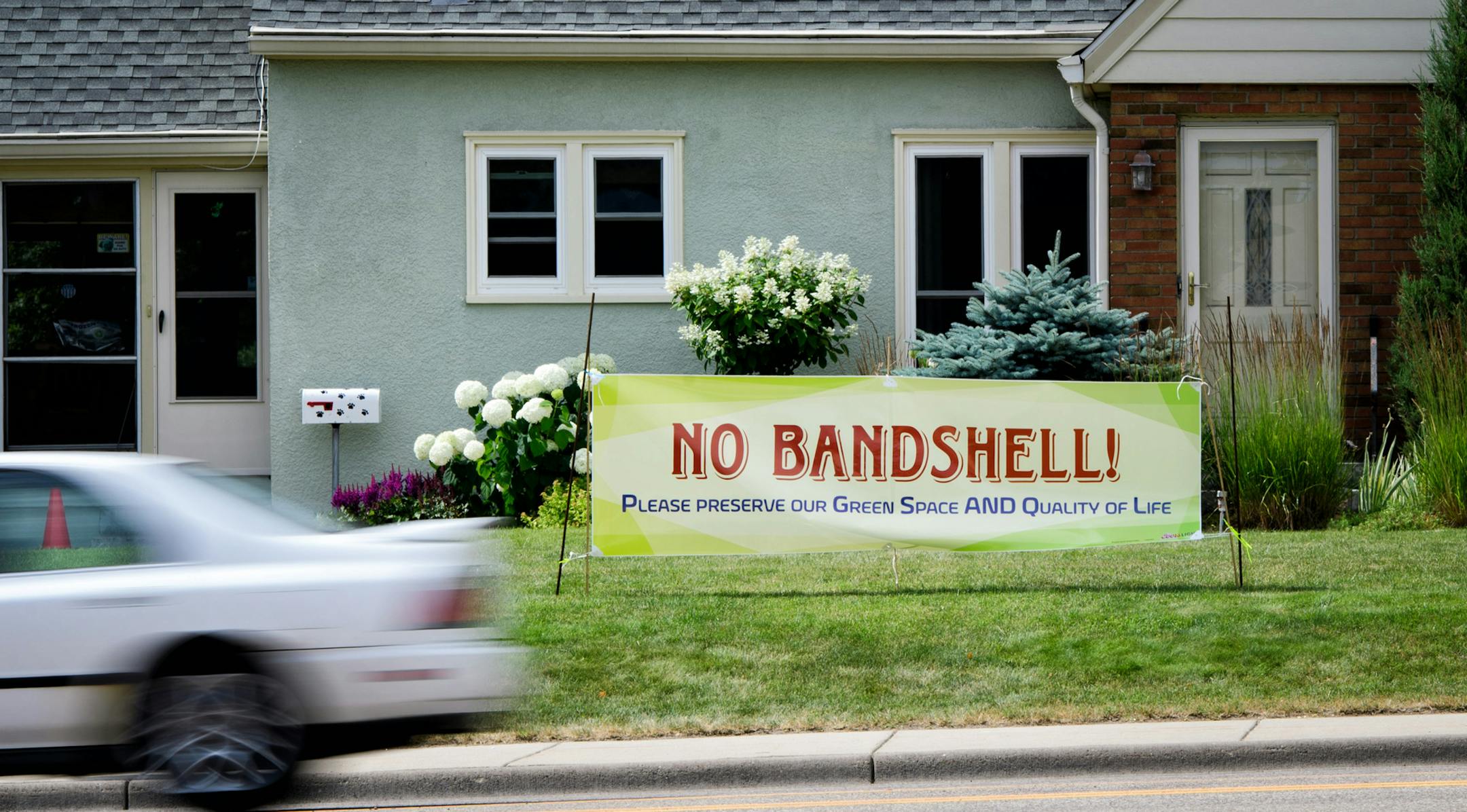 A house on 66th Ave, Richfield, across the street from Veterans Park, displays an anti-bandshell lawn sign. ] GLEN STUBBE * gstubbe@startribune.com Tuesday, July 5, 2016 After five years of dashed hopes, city officials and music fans in Richfield are again resurrecting their bid for a bandshell in Veterans Park. The $500,000 project has re-emerged after bids came in $60,000 over budget last summer. Many challenges have surfaced since 2011 when the bandshell was first proposed, from environmental