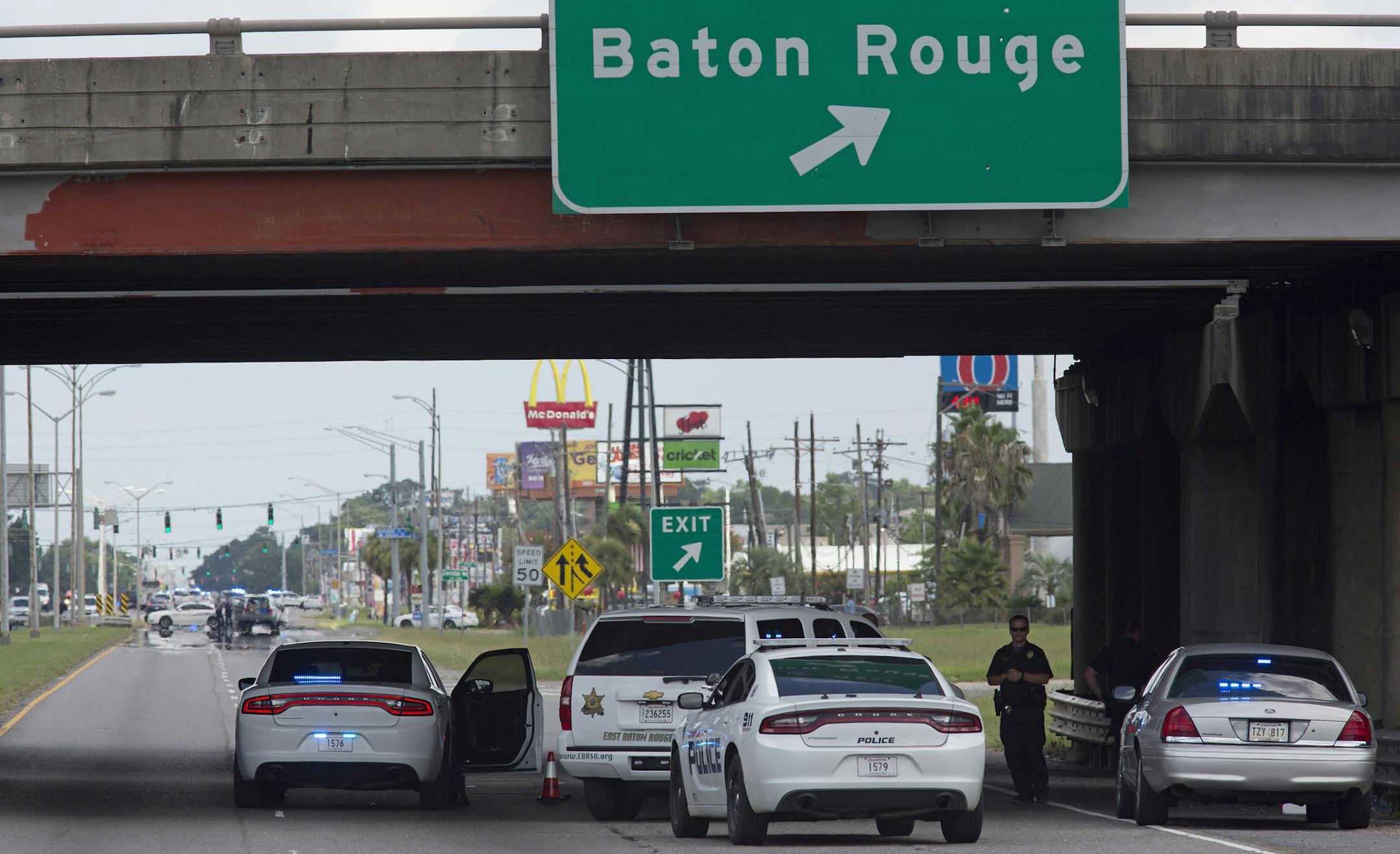 Baton Rouge Police block Airline Highway after police were shot in Baton Rouge, La., Sunday, July 17, 2016. At least three officers are confirmed dead and at least three others wounded after the shooting, a sheriff's office spokeswoman said Sunday. (AP Photo/Max Becherer) ORG XMIT: MIN2016071719301896