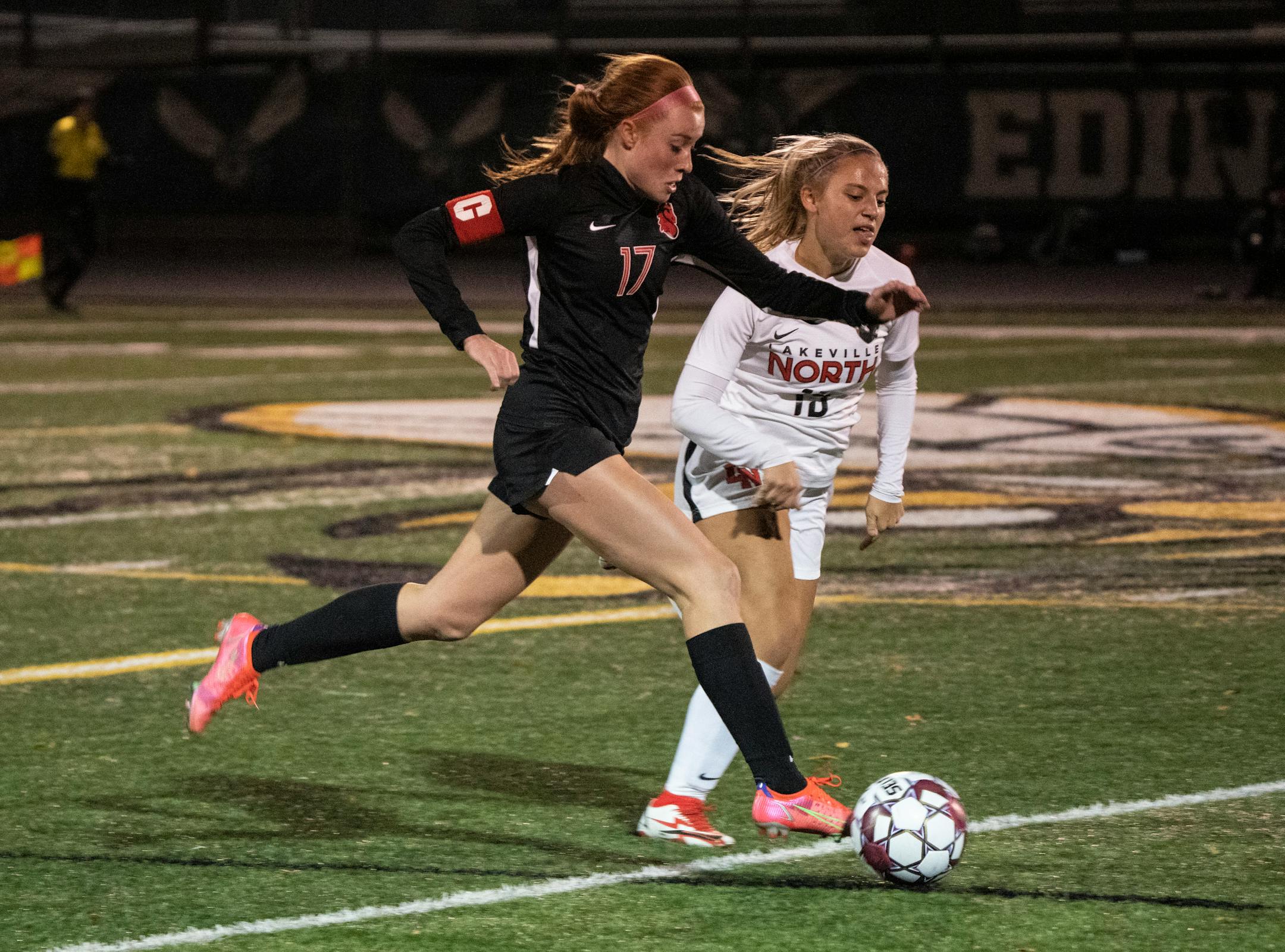 Stillwater Area midfielder Catherine Fredkove (17) runs with the ball as Lakeville North defender Hannah Slaikeu (15) guards in the second half. Stillwater defeated Lakeville North 1-0 in double overtime in the Class AAA quarterfinals in Edina, Minn., Tuesday, Oct. 26, 2021. ] RENEE JONES SCHNEIDER • renee.jones@startribune.com