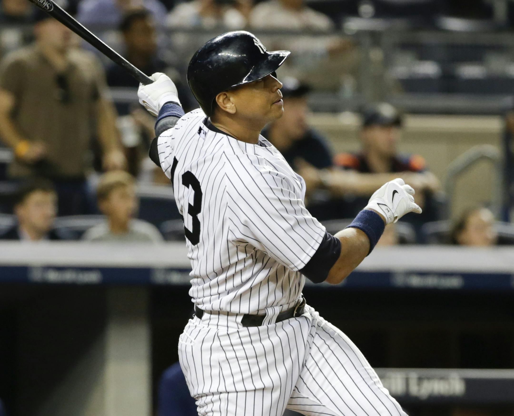 New York Yankees' Alex Rodriguez follows through on a grand slam during the seventh inning of a baseball game against the Minnesota Twins on Tuesday, Aug. 18, 2015, in New York. (AP Photo/Frank Franklin II)