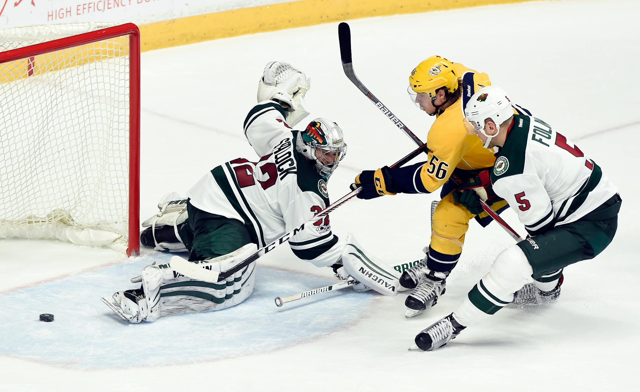Nashville Predators left wing Kevin Fiala (56), of Czech Republic, scores a goal past Minnesota Wild goalie Alex Stalock (32) as defenseman Christian Folin (5), of Sweden, defends during the second period of an NHL hockey game Saturday, April 1, 2017, in Nashville, Tenn. (AP Photo/Mark Zaleski)