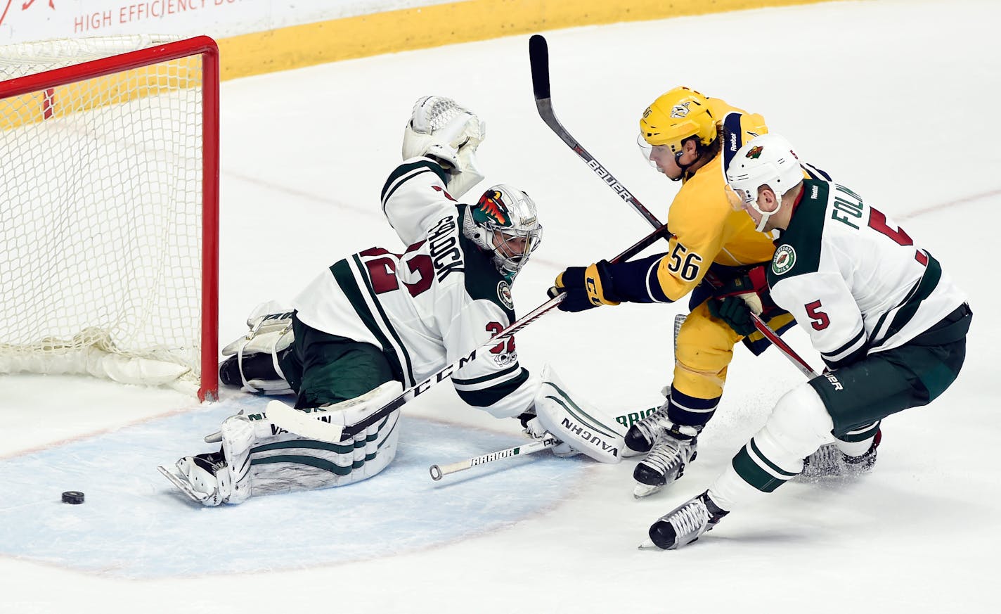 Nashville Predators left wing Kevin Fiala (56), of Czech Republic, scores a goal past Minnesota Wild goalie Alex Stalock (32) as defenseman Christian Folin (5), of Sweden, defends during the second period of an NHL hockey game Saturday, April 1, 2017, in Nashville, Tenn. (AP Photo/Mark Zaleski)