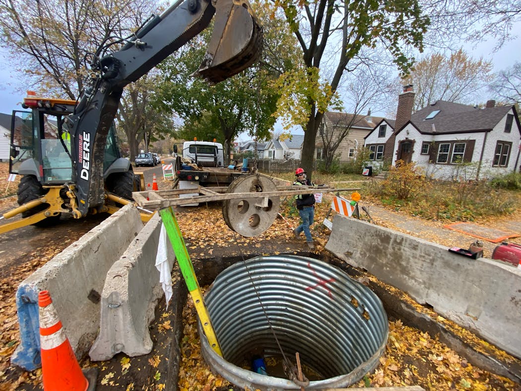 Minneapolis utility workers clean and line a water main pipe near 47th Ave S and Dowling Street in Minneapolis.