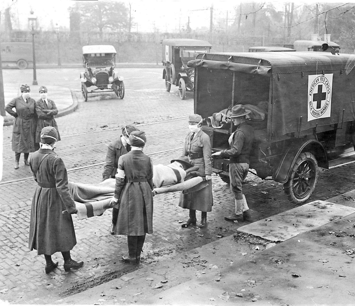 Members of the American Red Cross remove Spanish influenza victims from a house at Etzel and Page avenues in 1918. (St. Louis Post-Dispatch file photo/TNS) ORG XMIT: 1605745