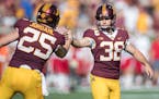 Minnesota's place kicker Emmit Carpenter celebrated after a field goal with teammate Payton Jordahl during the second quarter as Minnesota took on Mia