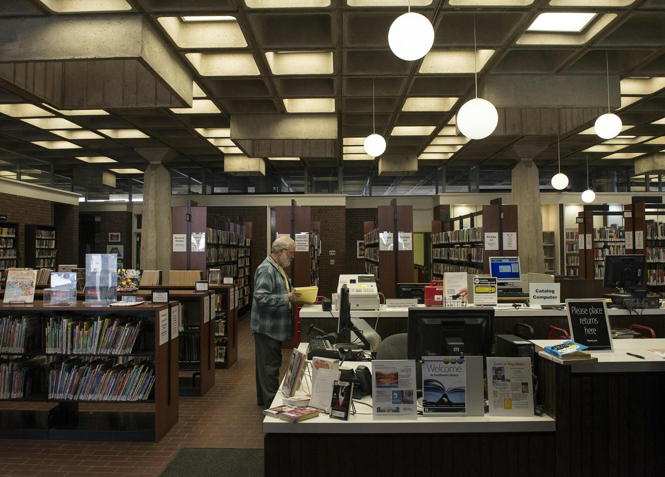Stacks of books line the walls inside the Southeast Library in Dinkytown.