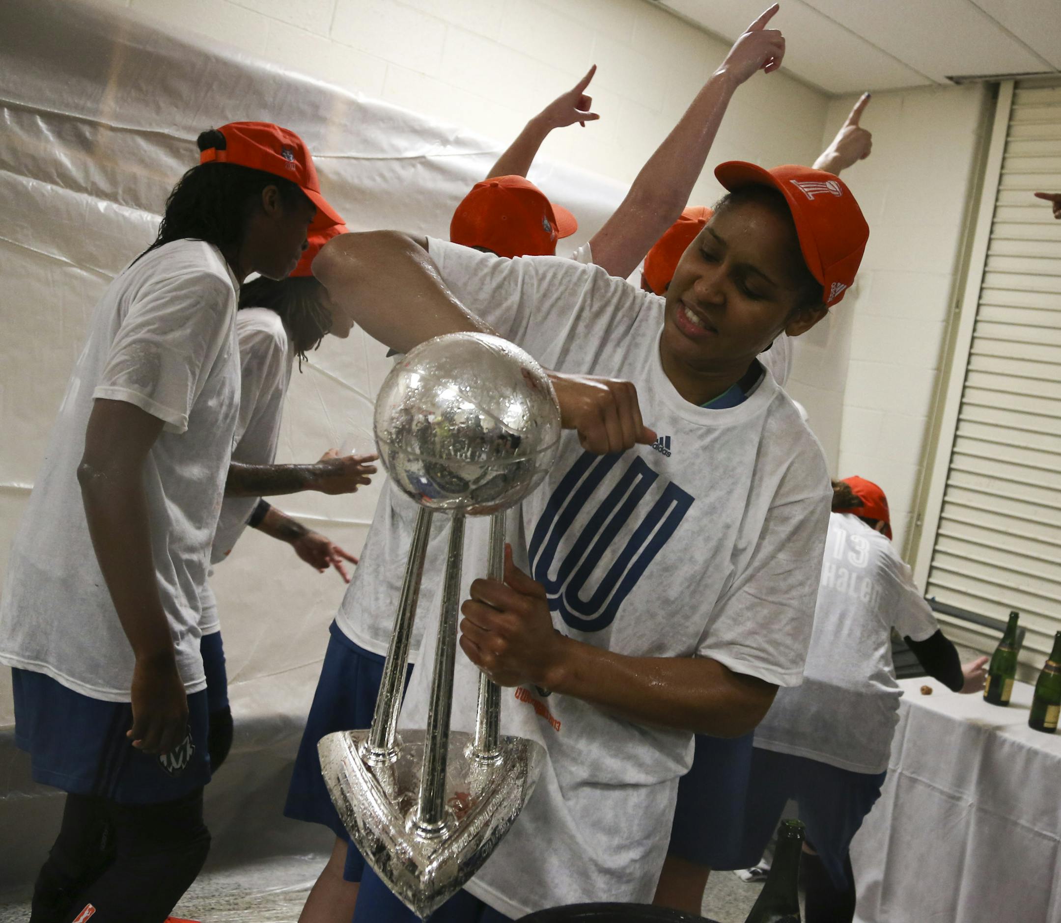 Maya Moore of the Minnesota Lynx cleans off the championship trophy as she celebrates their victory over the Atlanta Dream after Game 3 of the WNBA finals on Thursday, October 10, 2013, at the Gwinnett Center in Duluth, Ga. Minnesota won 86-77 to capture the championship.] RENEE JONES SCHNEIDER • reneejones@startribune.com