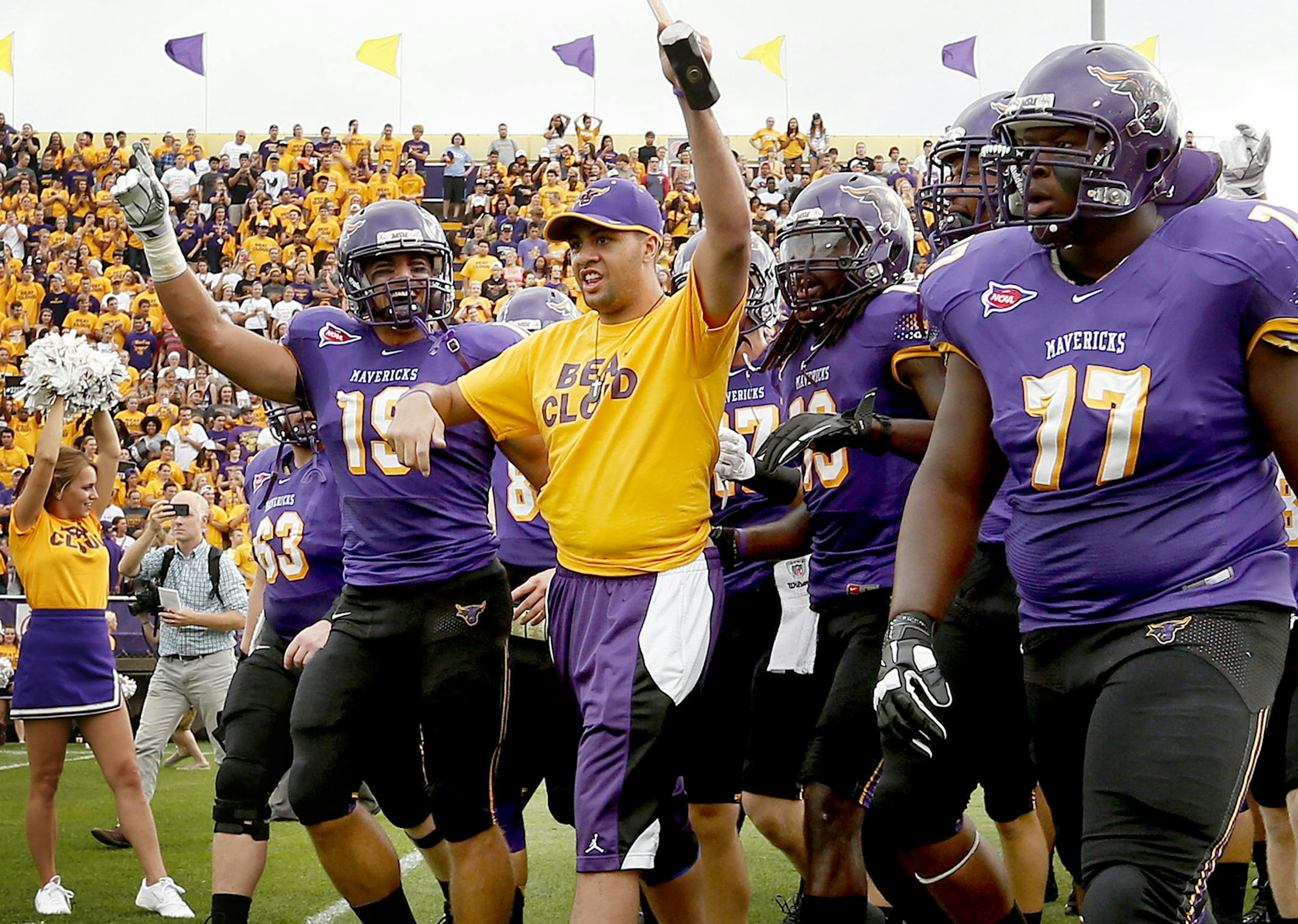 Isaac Kolstad led the Minnesota State, Mankato Mavericks football team on the field at Blakeslee Stadium before Thursday night's game vs. St. Cloud State. ] CARLOS GONZALEZ cgonzalez@startribune.com - September 4, 2014, Mankato, Minn., Minnesota State, Mankato, Blakeslee Stadium, Former Minnesota State, Mankato football player Isaac Kolstad, who was seriously injured in an assault in downtown Mankato in May, returns as honorary team captain for the Mavericks' season opener against St. Cloud Stat