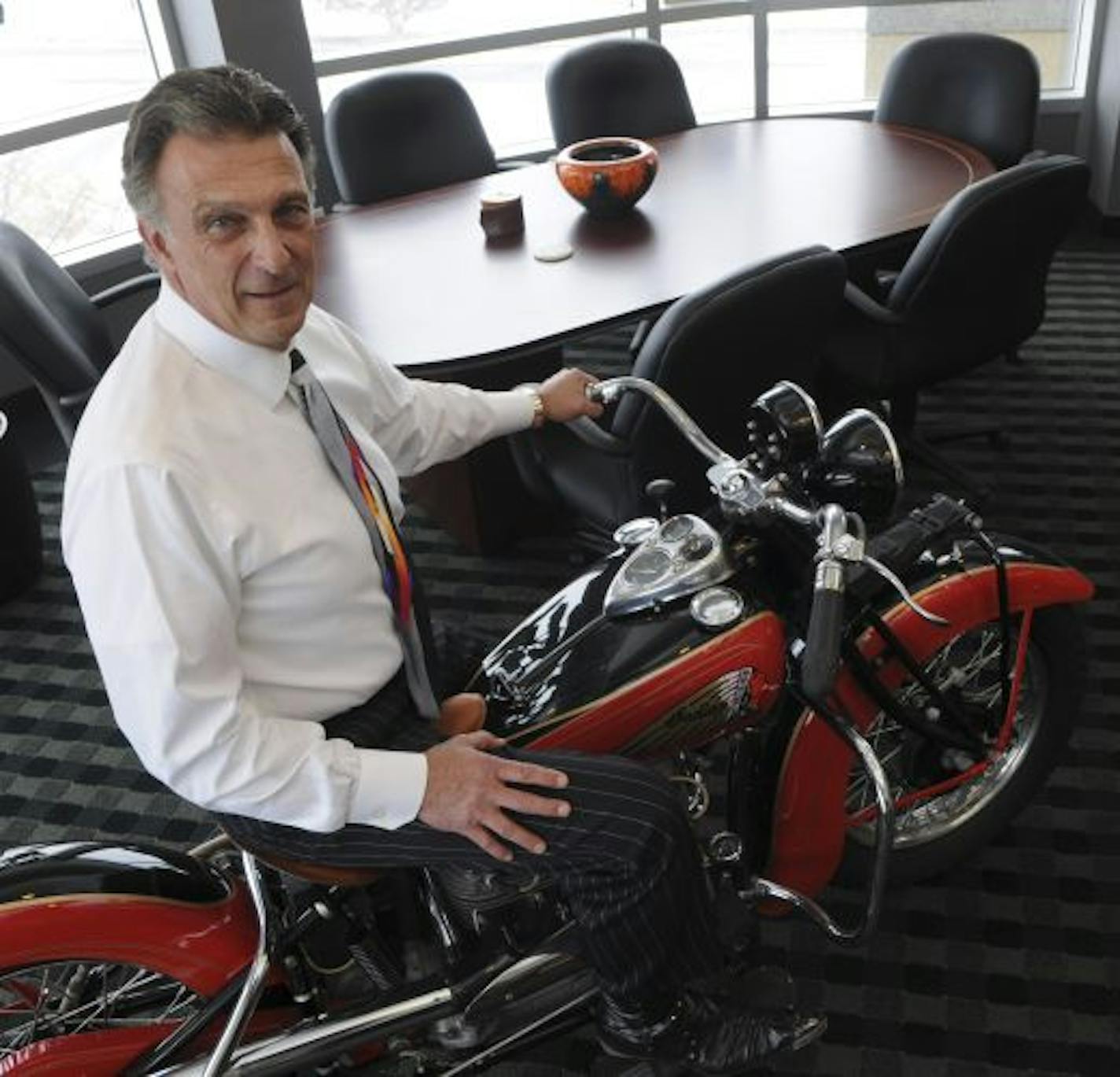 Paddock Laboratories CEO Bruce Paddock still enjoys many of the same interests he had growing up in Duluth, including motorcycles. A 1939 Indian Ace in his office is a tipoff.