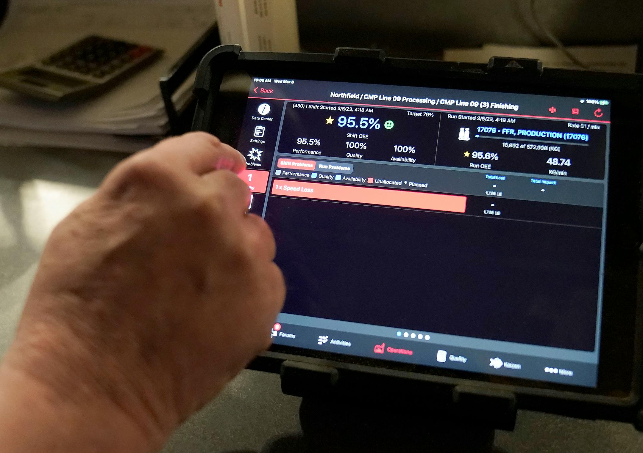 Wade Armstrong, a processing specialist, uses a computer pad to monitor progress of a cereal batch.