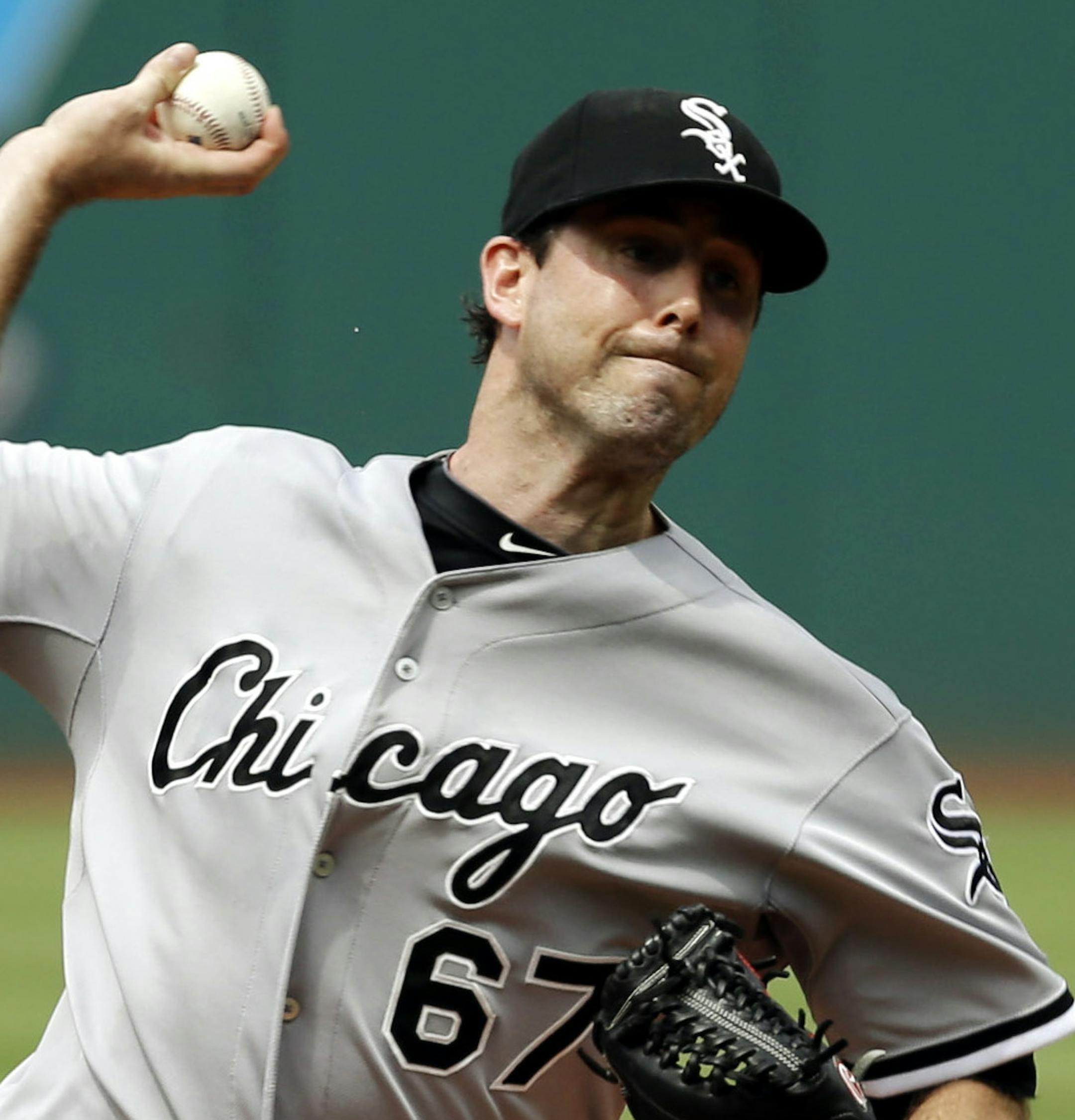 Chicago White Sox starting pitcher Scott Carroll delivers against the Cleveland Indians on the first inning of a baseball game Saturday, July 12, 2014, in Cleveland. (AP Photo/Mark Duncan)