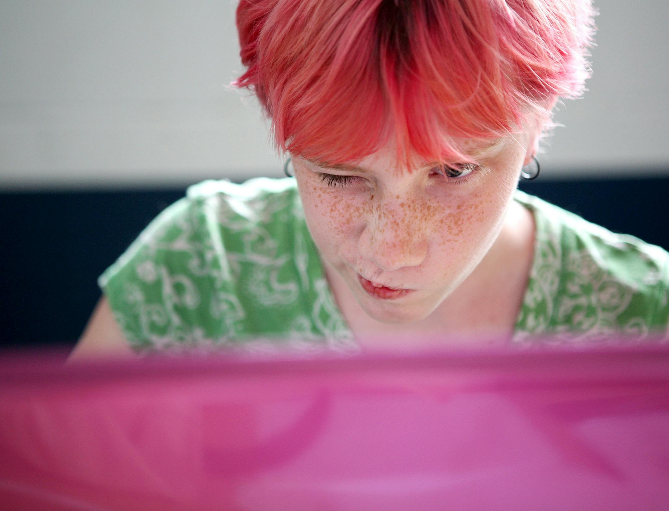 Jaiden Julson, 11, of Brooklyn Park concentrates on adding a progression of musical notes to her animation project in Scratch at CoderDojo Twin Cities at Clockwork Active Media in Minneapolis July 13, 2013. (Courtney Perry/Special to the Star Tribune)