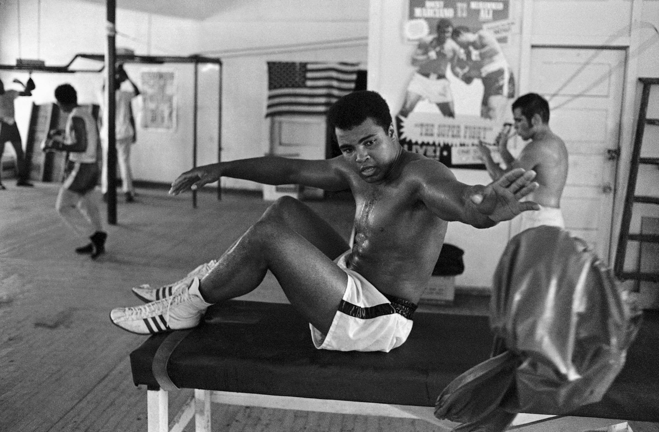 A perspiring former heavyweight champion Muhammad Ali (Cassius Clay) tosses aside a sweat jacket while working out in a gym at Miami Beach on Sept. 16, 1970, where he started his training for the October 26 bout with Jerry Quarry in Atlanta. (AP Photo/Jim Kerlin) ORG XMIT: APHS282471