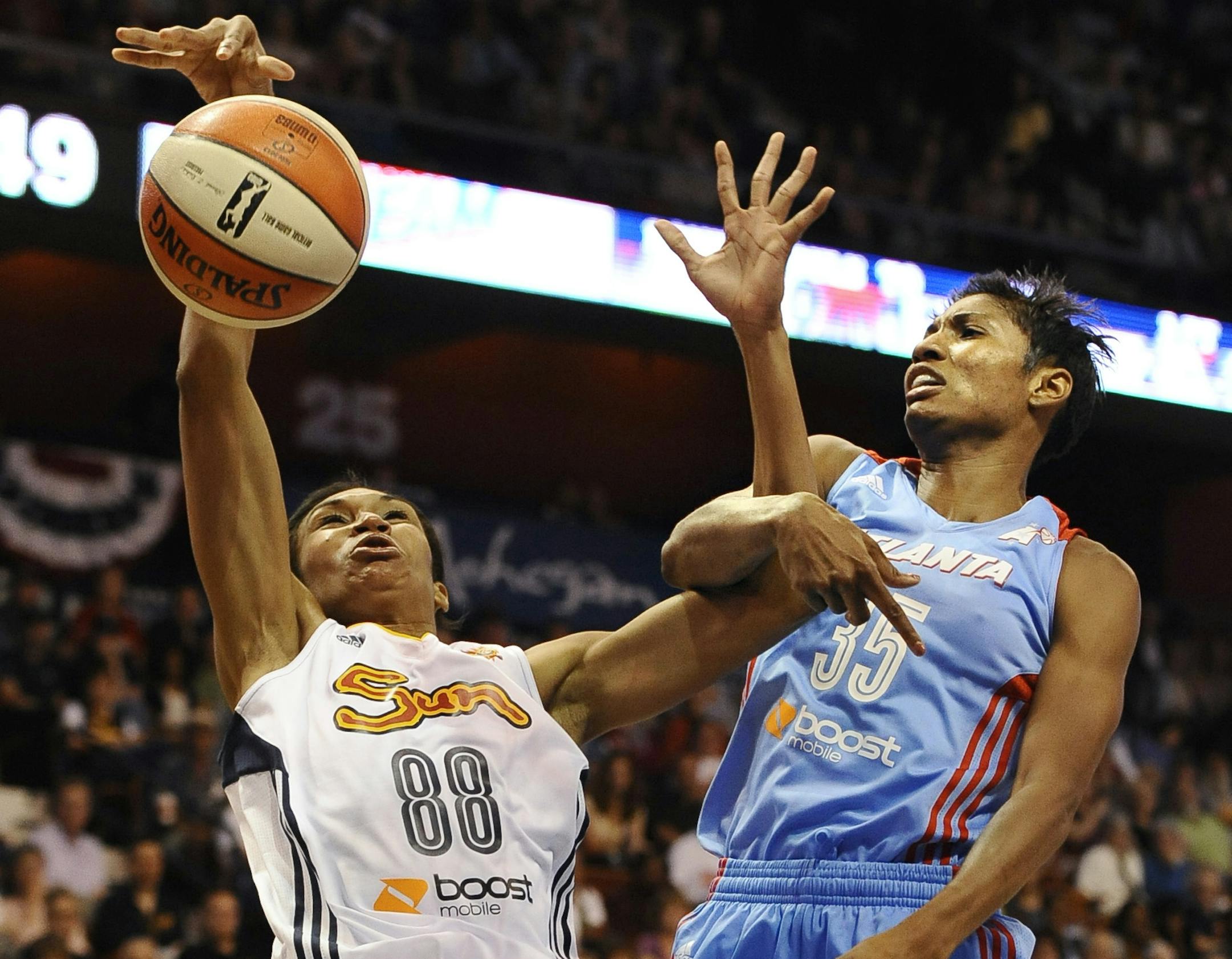 Connecticut Sun's Iziane Castro Marques of Brazil, left, tangles with Atlanta Dream's Angel McCoughtry during the second half of a WNBA basketball game in Uncasville, Conn., Sunday, June 23, 2013. Atlanta won 78-77. (AP Photo/Jessica Hill) ORG XMIT: CTJH105