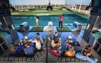 Customers relax and play at a Topgolf center.