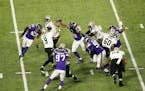 New Orleans Saints quarterback Drew Brees was surrounded by purple Vikings jerseys while throwing under pressure in the second quarter of Sunday's NFC