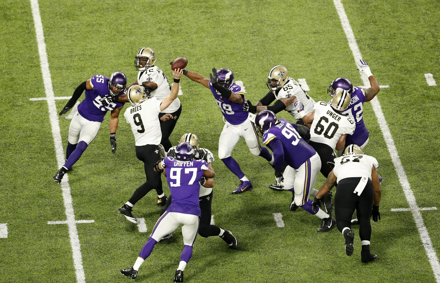 New Orleans Saints quarterback Drew Brees was surrounded by purple Vikings jerseys while throwing under pressure in the second quarter of Sunday's NFC divisional playoff game.