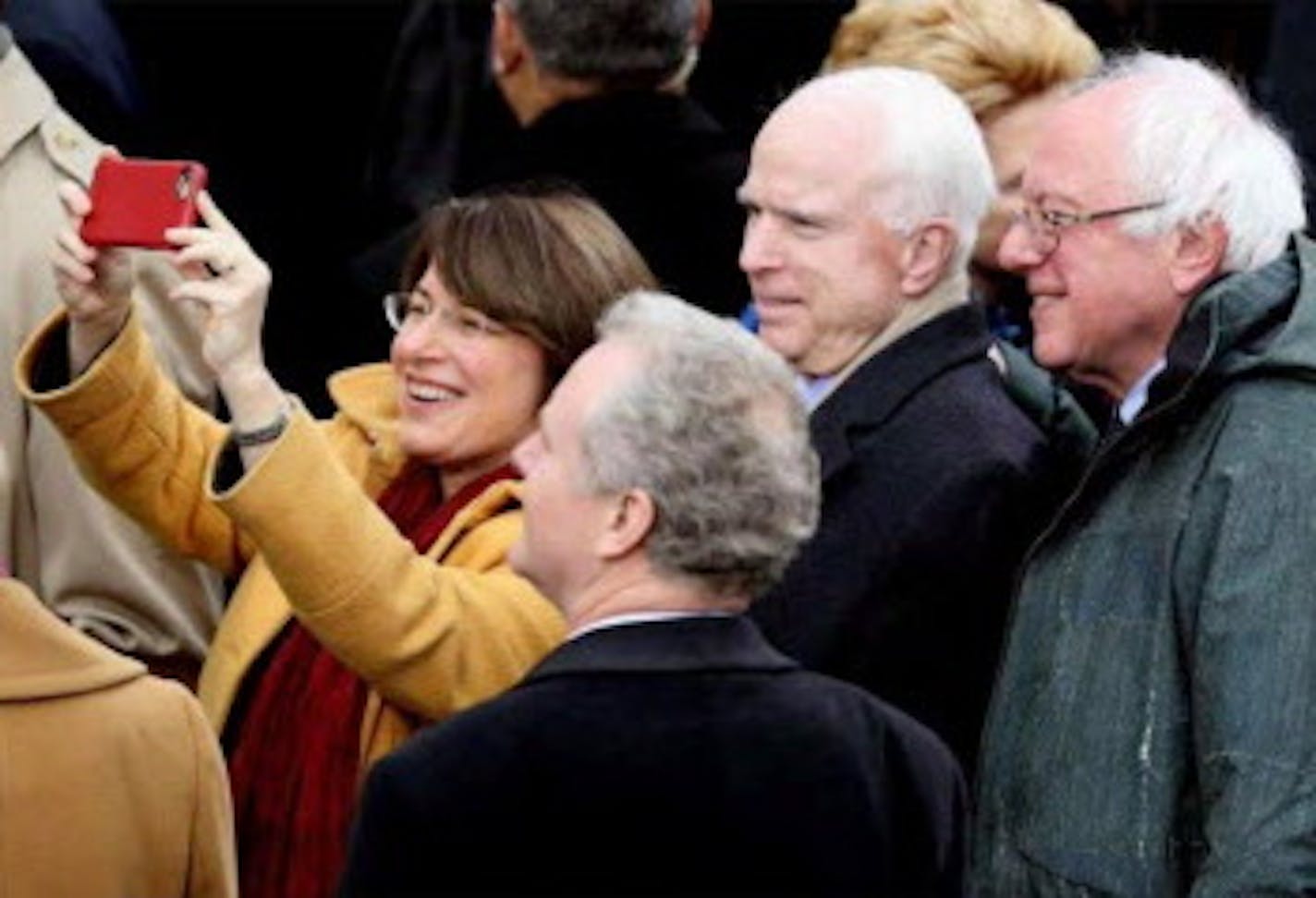 A screen shot of a slide show of images from the inauguration of Donald J. Trump on sfgate.com shows a photograph of Minnesota Sen. Amy Klobuchar taking a selfie with Arizona Sen. John McCain and Vermont Sen. Bernie Sanders. The image, as initially transmitted by the wire service Getty Images, referred to the senior senator from Minnesota as &#x201c;A woman.&#x201d;