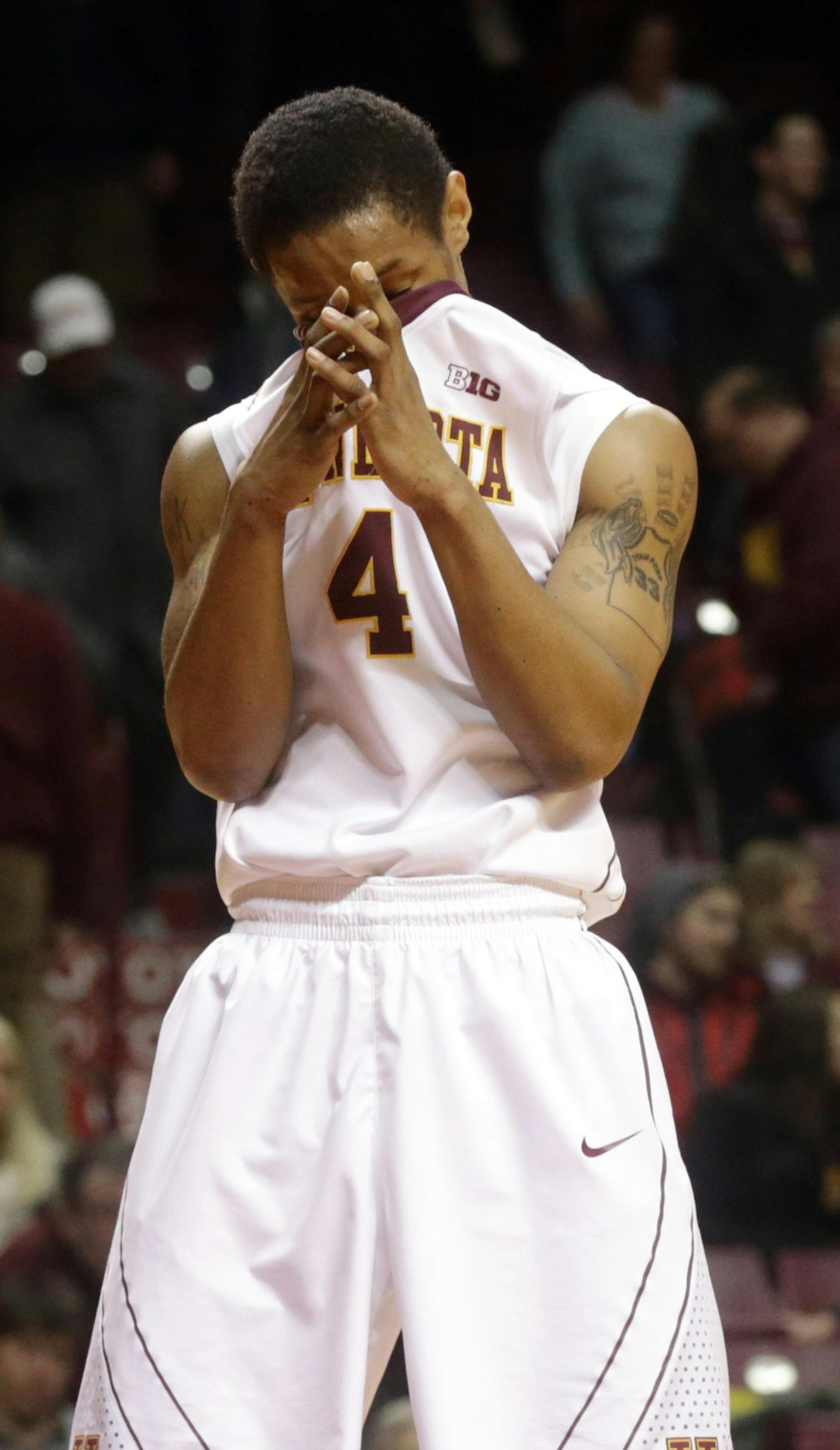Minnesotaís DeAndre Mathieu reacts in the waning minutes of an NCAA college basketball game Wednesday, Feb. 18, 2015, in Minneapolis. Northwestern won 72-66. Looking on, background, is head coach Richard Pitino. (AP Photo/Jim Mone) ORG XMIT: MIN2015022216554233