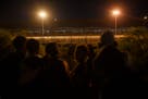 Migrants waiting to cross the U.S.-Mexico border on the night President Joe Biden signed an executive order effectively closing it to asylum seekers i