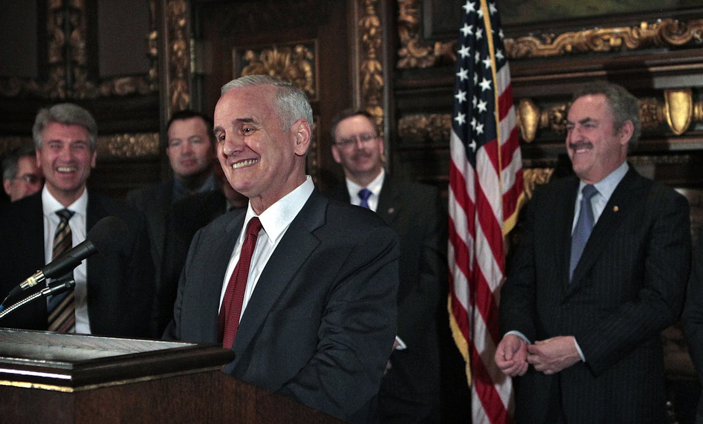 Gov. Mark Dayton (foreground),Minneapolis Mayor R.T. Rybak (left), Vikings owner Zygi Wilf (right), lawmakers and others held a news conference at the Capitol to announce an agreement to build a new stadium on the current Metrodome site.